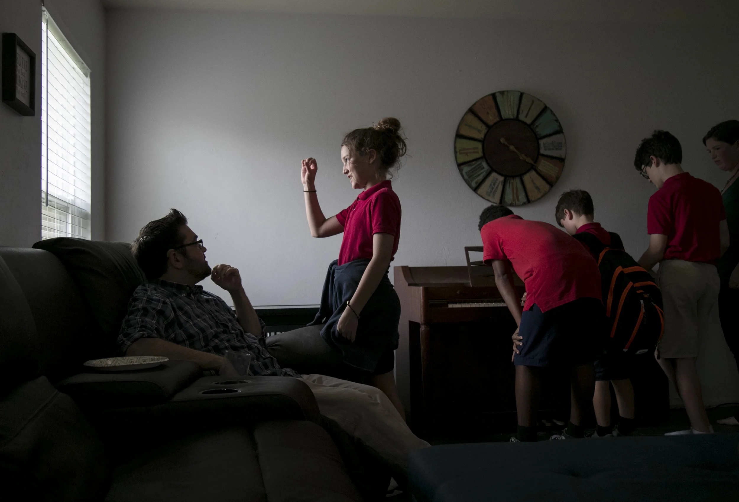  Kassidy Kain, 11, center, tells her dad Mike about her day at school after she and her siblings got home from school on Friday, November 17, 2017, in Lehigh Acres. 