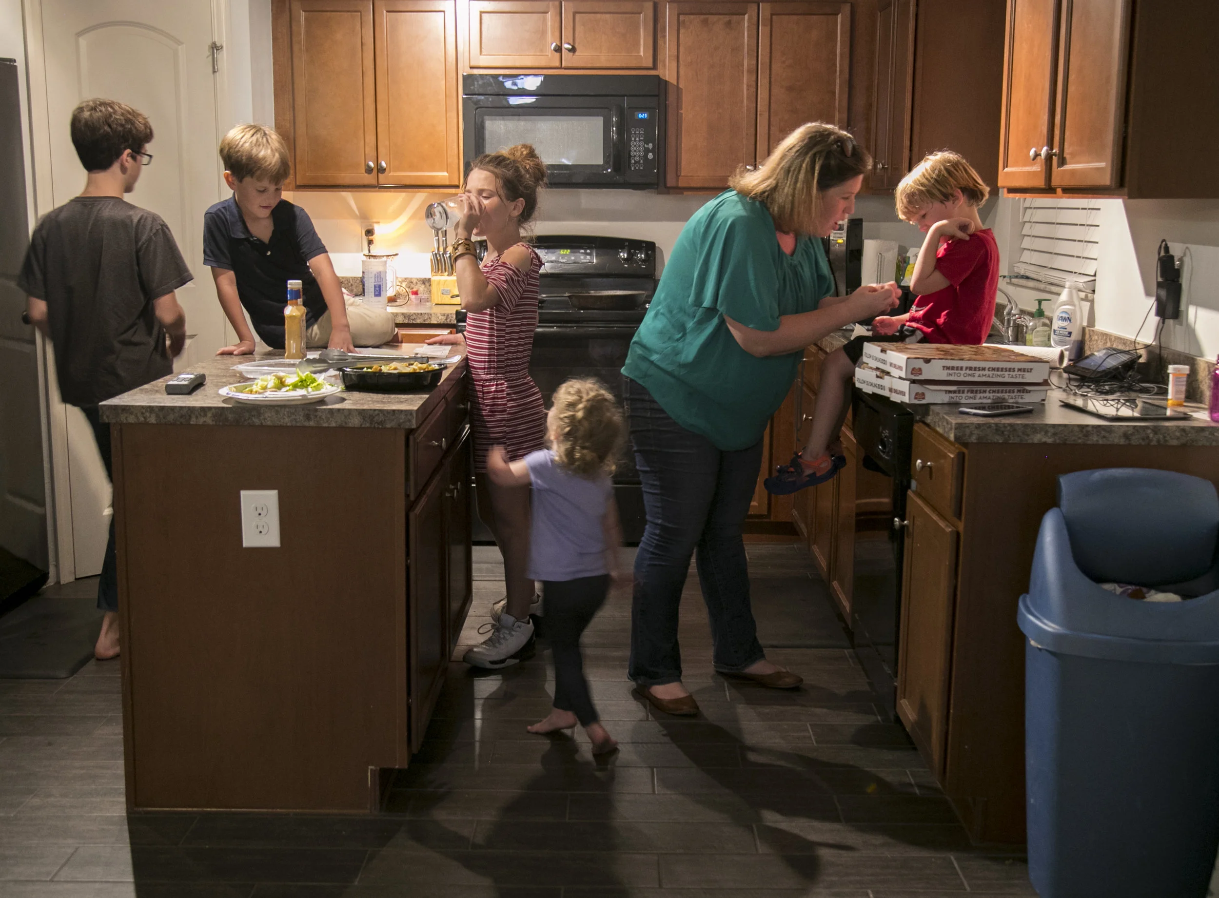  Karen Kain puts a Band-Aid on a scrape on Jonah’s arm after he fell outside playing with his siblings and friends. While her husband Mike was sick and doing nightly dialysis, she did the bulk of the parenting. 