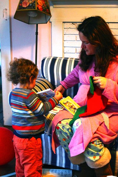 Helping Mom opens presents - books, of course!