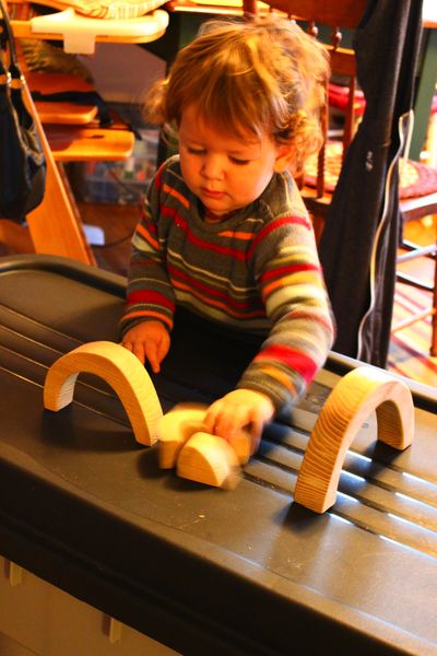 Daddy made these neat wooden arches. We're going to stain them rainbow colors.