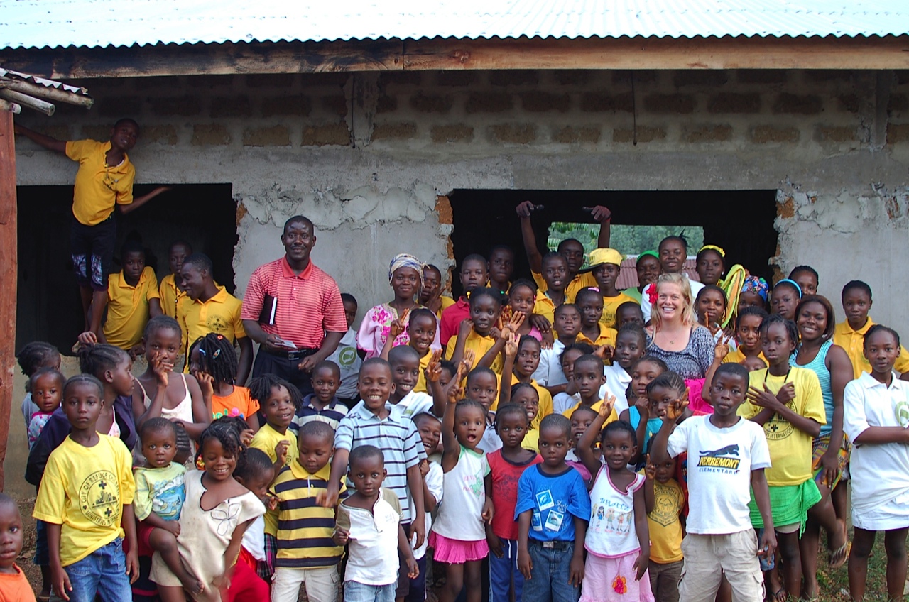 Shannon Lerach surrounded by the children she provided trauma-informed counseling services to on Peace Island in Liberia.
