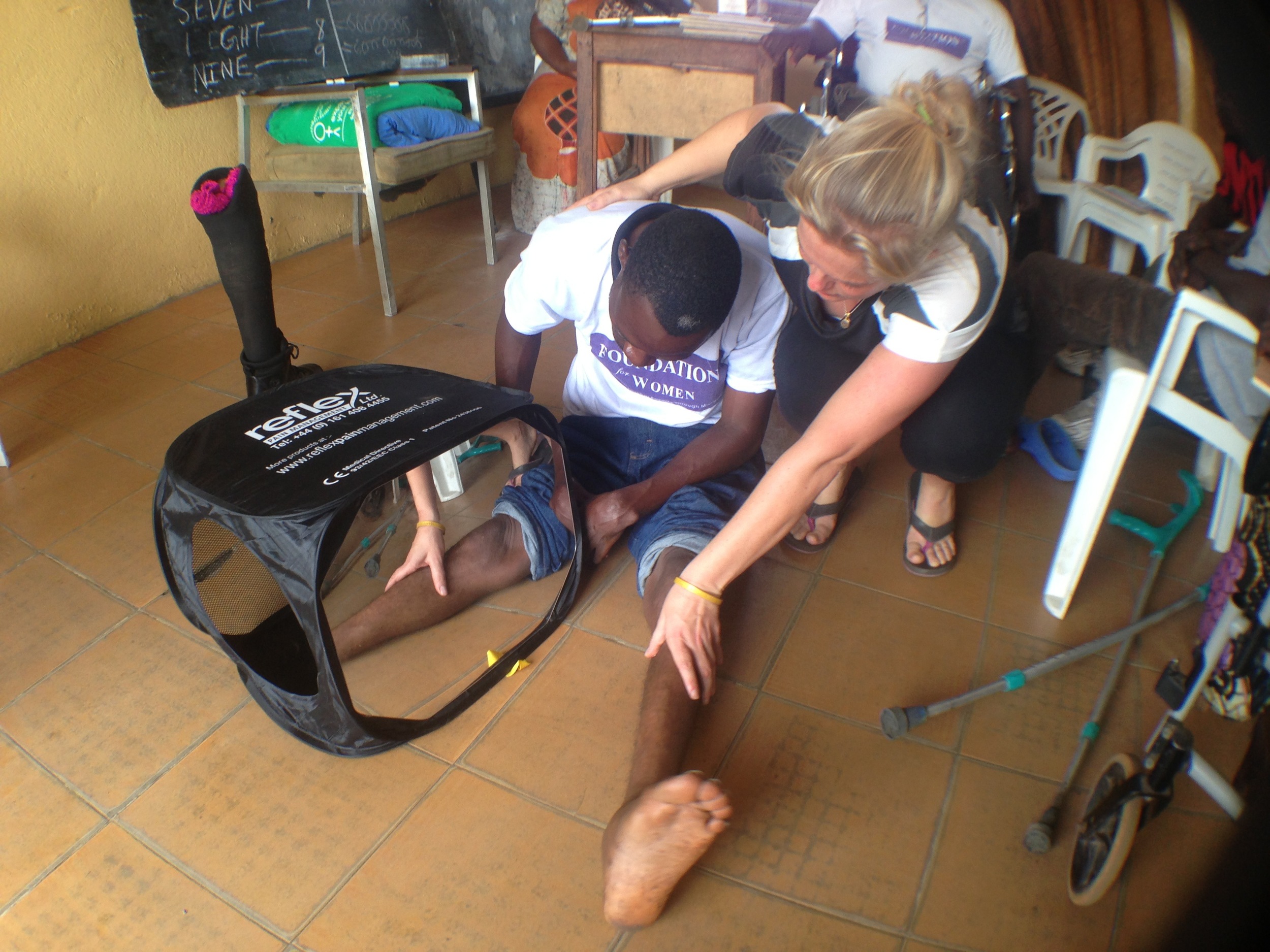 Shannon Lerach using the Mirroring Technique to treat phantom limb pain at the Group of 77 in Liberia.