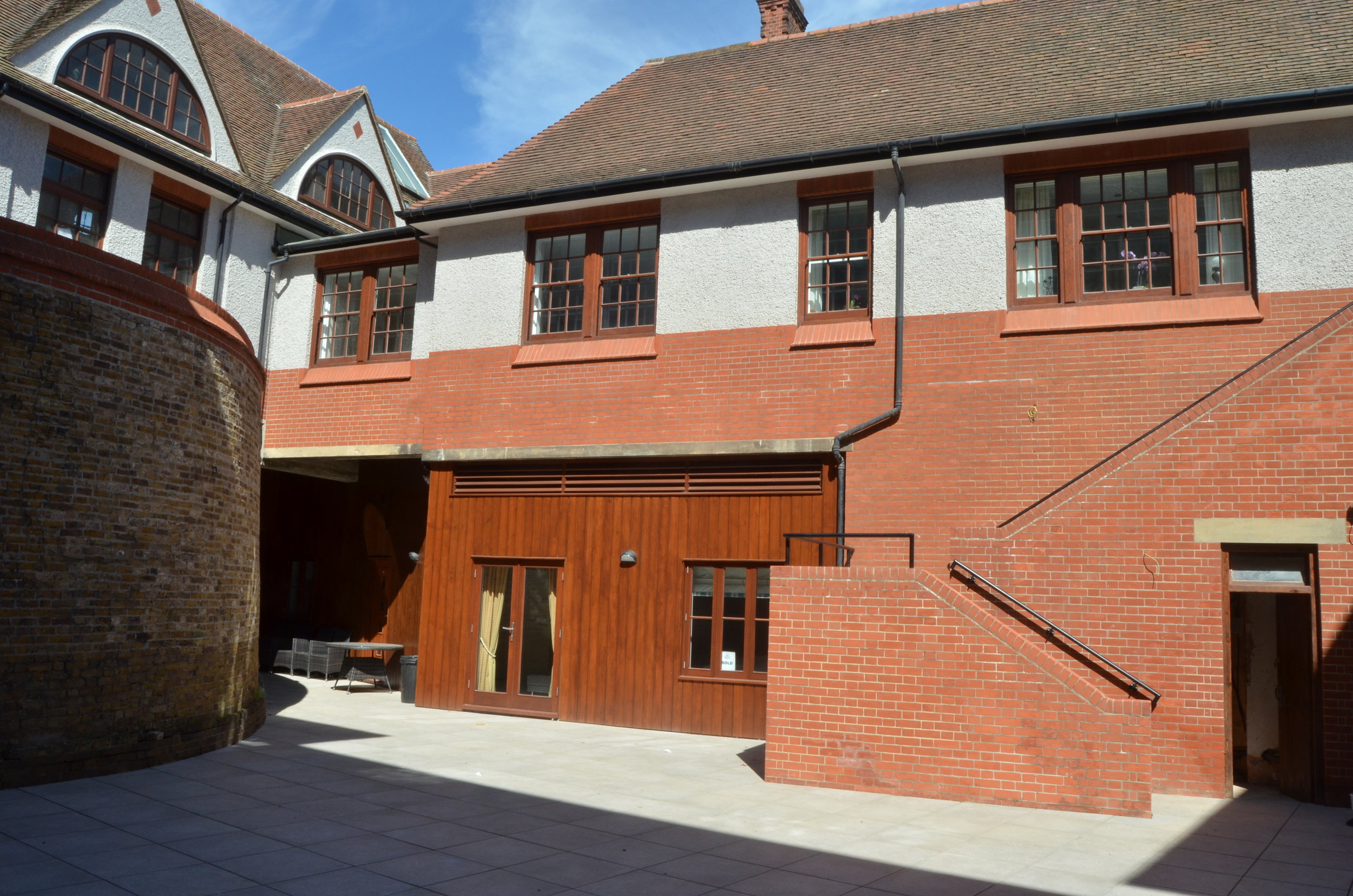  The existing walls of the Martello Tower, in London bricks, are visible internally in the courtyard and forms part of the lower ground floor/ basement units 