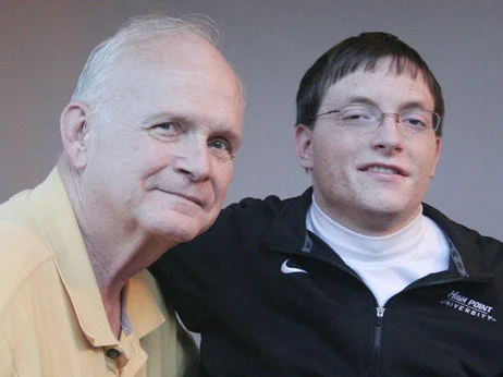 Ernest Greene (left) accompanied Collin Smith to college. When Collin graduated, the school awarded Ernest an honorary degree.
