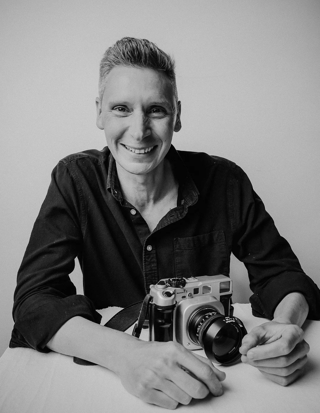 Central Coast Artist Portrait & Branding Photographer Christopher Perkins with his Medium Format Film Camera. Shot in Black & White. Relaxed and real.