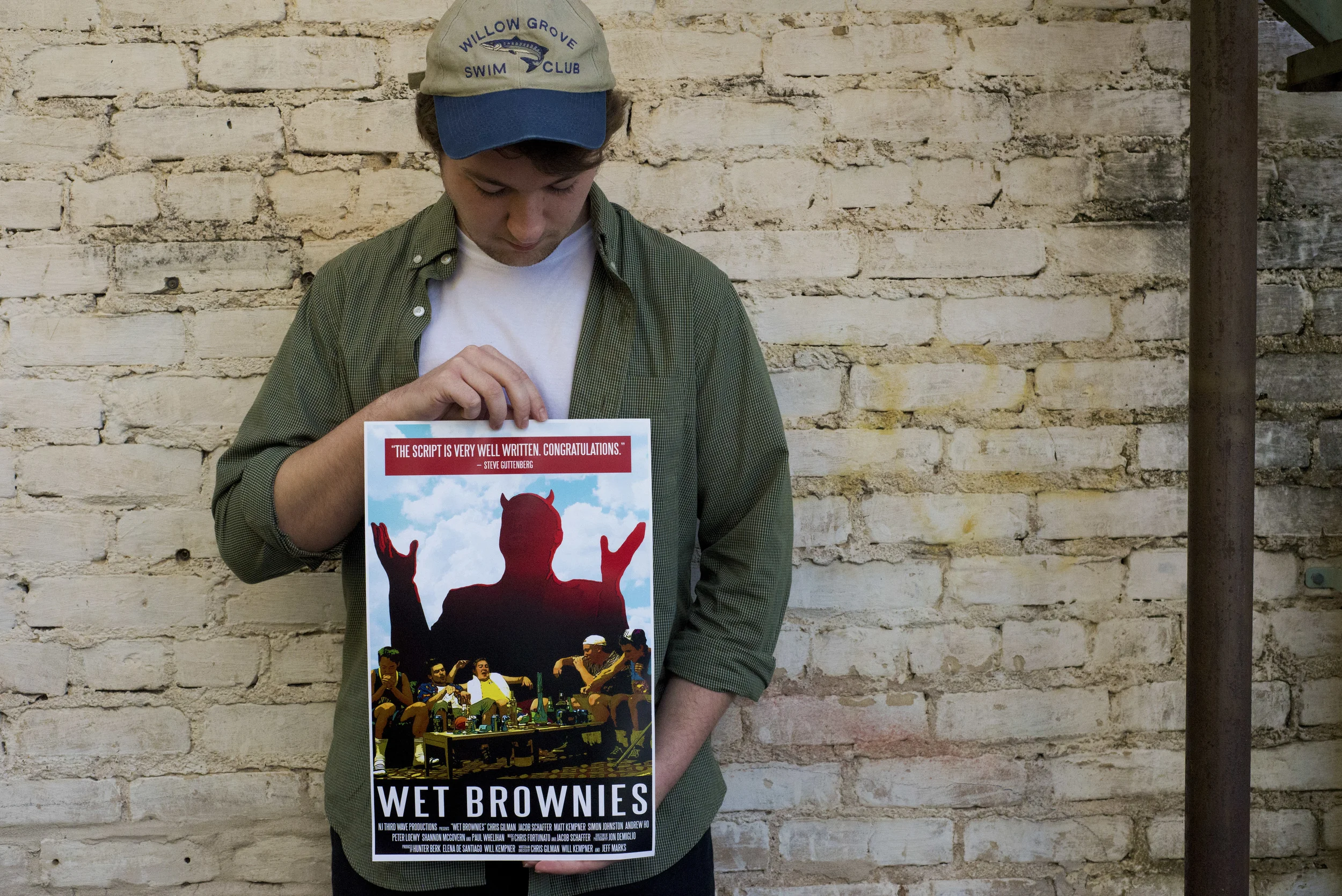 Debut film director Chris Gilman holds the poster for "Wet Brownies," releasing Saturday, Feb. 14. 