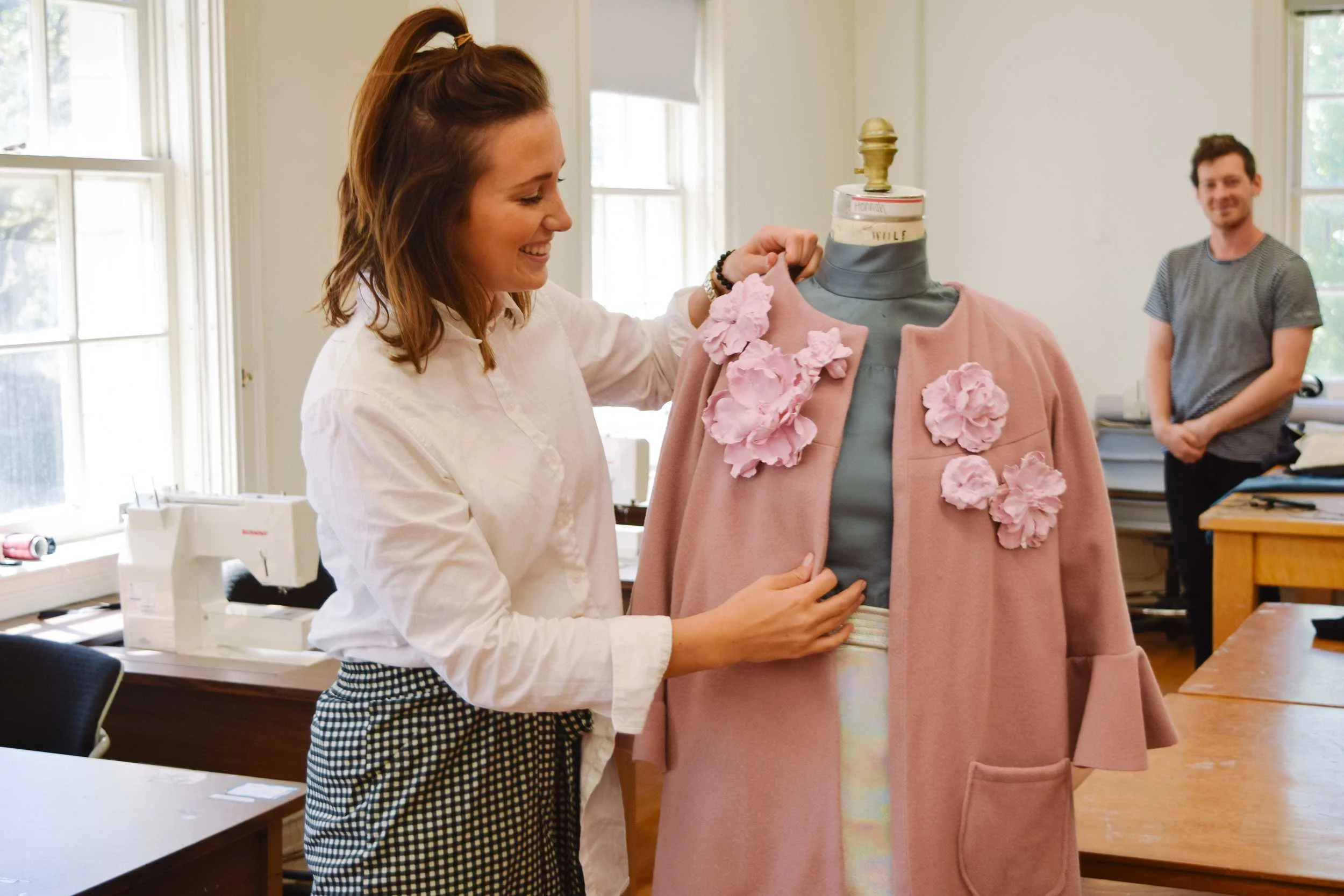 Hannah’s look is a modern take on 60’s fashion with a metallic leather skirt, grey turtleneck, and pink petticoat.