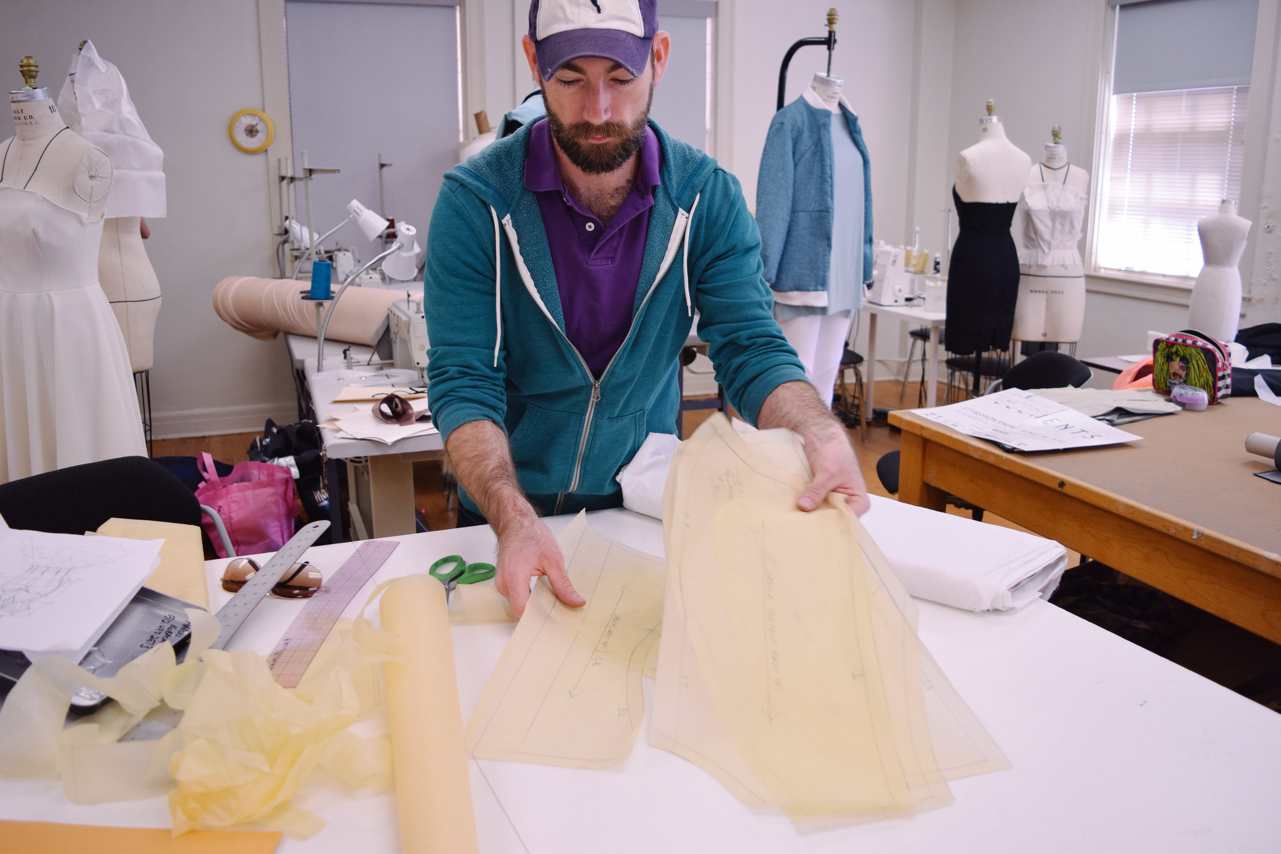 Aaron lays out fabric and stencils to start on his next piece.