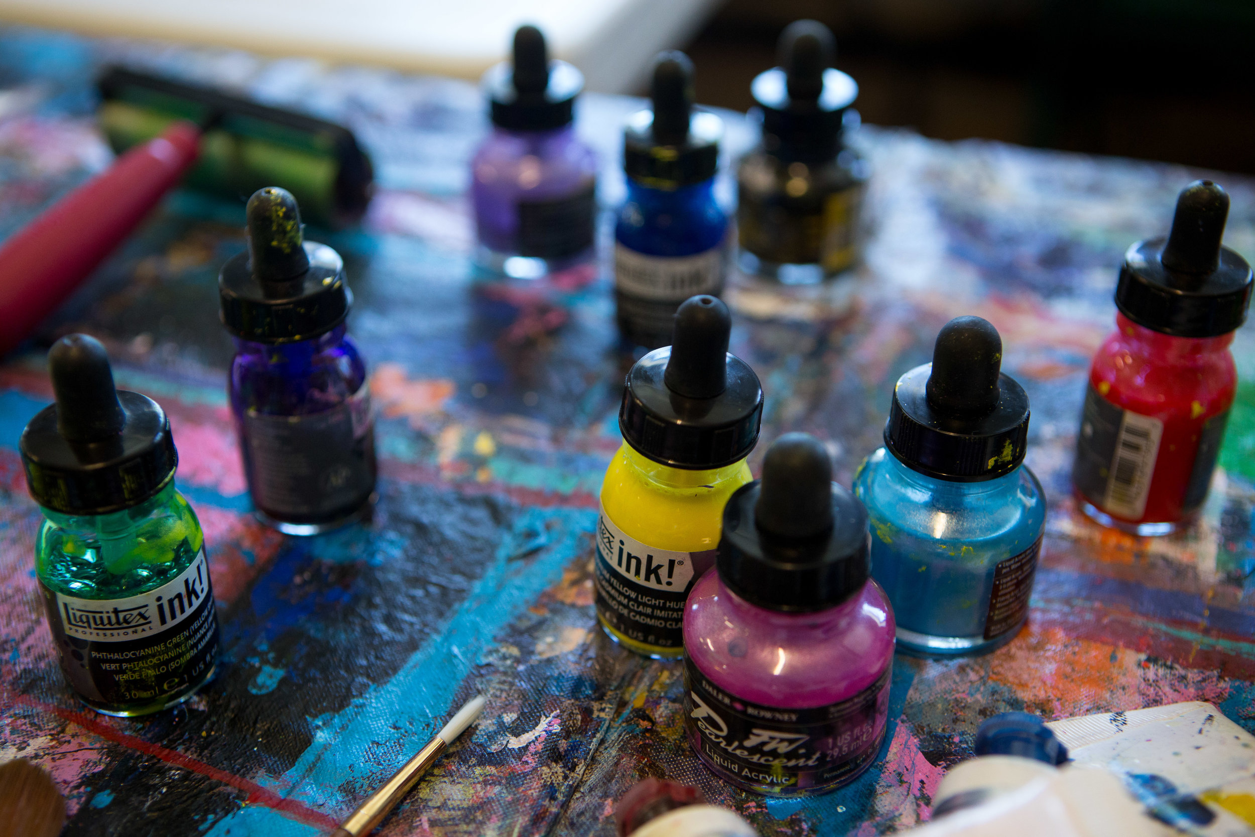 Various acryclic paints are laid out on the table in the AFTS studio. 
