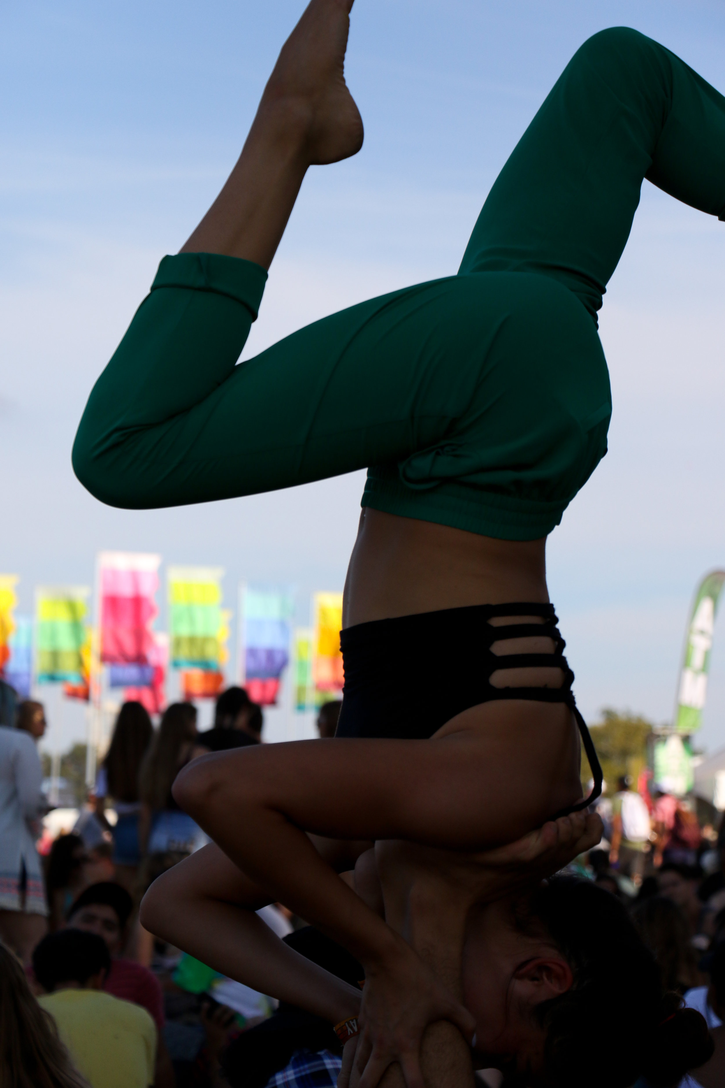 A couple takes a break from the fest to do a bit of yoga.