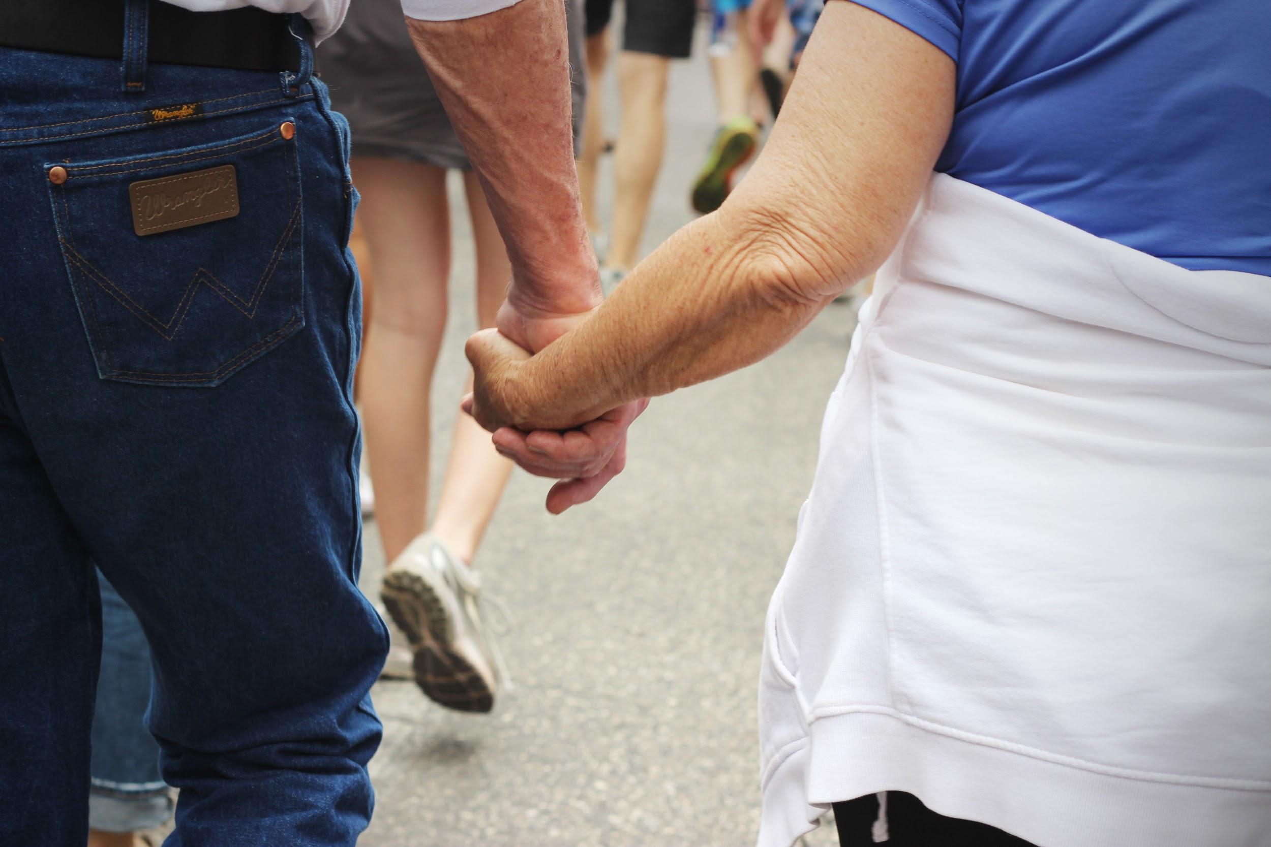 Loved ones lock hands as they march.