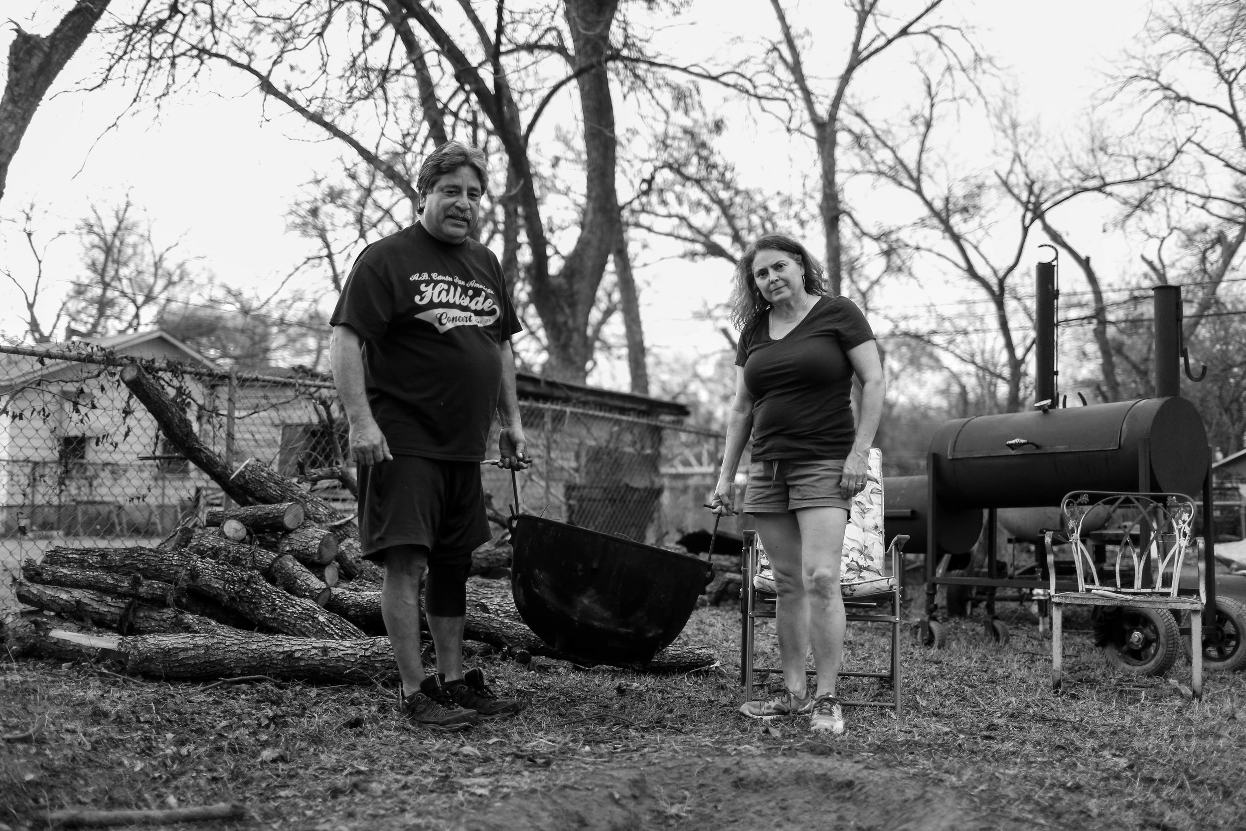 Jesse and his wife Diana Cortez hold a pot, that is used to make tamales outside in a small pit in the ground. They have been carrying on this tradition for years.