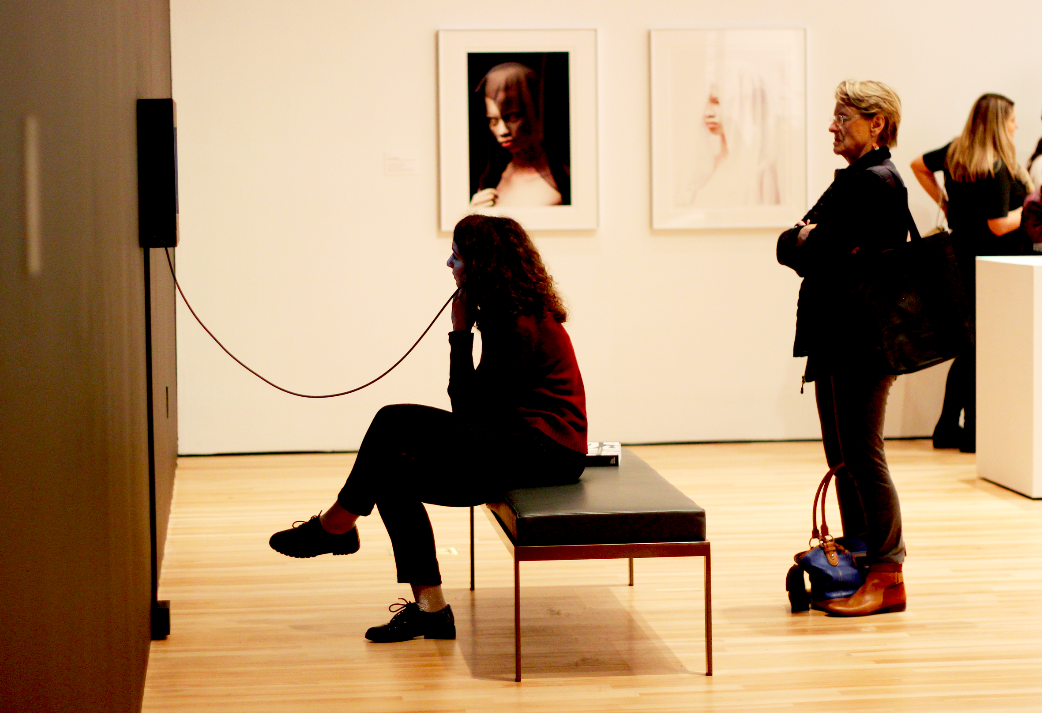 Visitors of the exhibit interact and engage with the pieces on display.