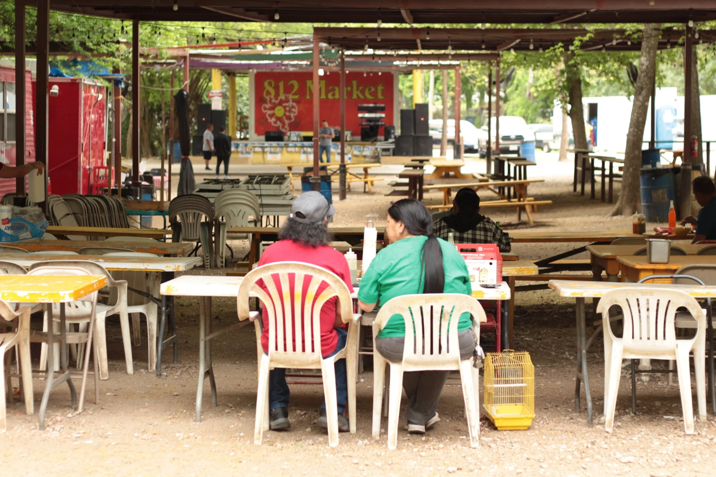 A couple enjoys authentic tacos from a food truck at the 812 Market cafeteria on a relaxing Saturday morning