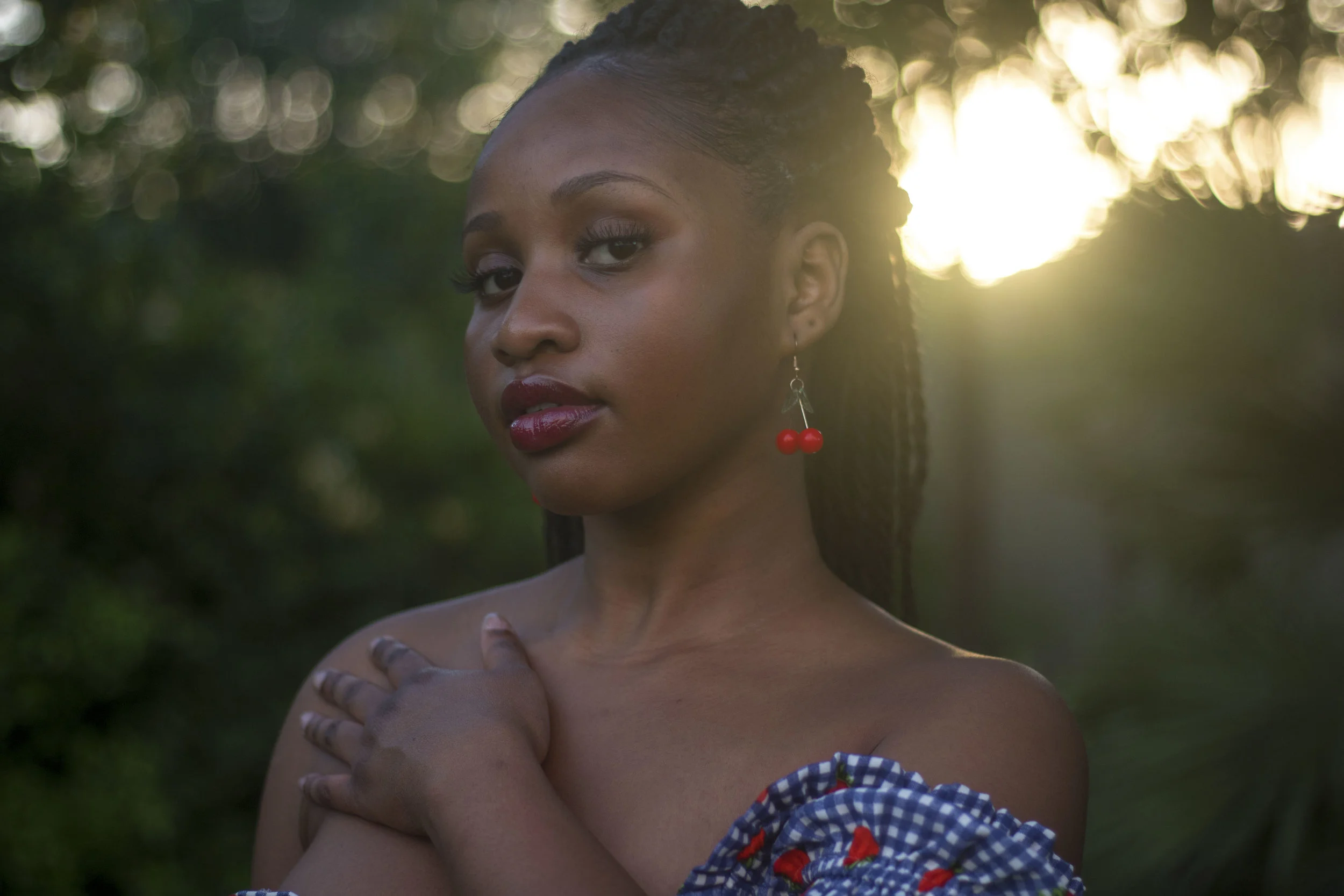 Kadija Baldé rocks a fruit-inspired look consisting of cranberry earrings paired with a strawberry dress.