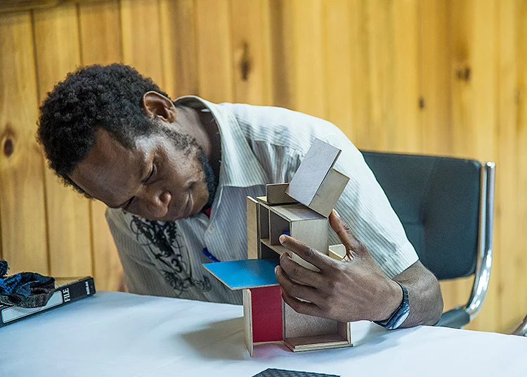 Mr Mevan Gera, Tainabuna Village School Board (Treasurer) inspects the 1:5 scale model of School-in-a-Box at a presentation held in Tufi, May 2015. Photo © Zoe Reynolds