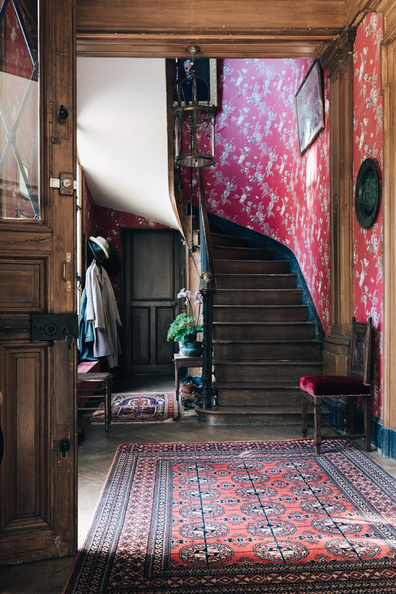 The entrance hall. Through the door on the left you'll find the petit salon - a cosy, casual room off the kitchen where the family eats breakfast. Behind us is the door into the grand salon and to the right is the formal dining room.