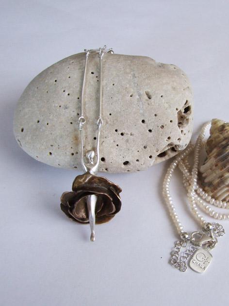 11 Woman with rose skirt necklace with pearl.jpg