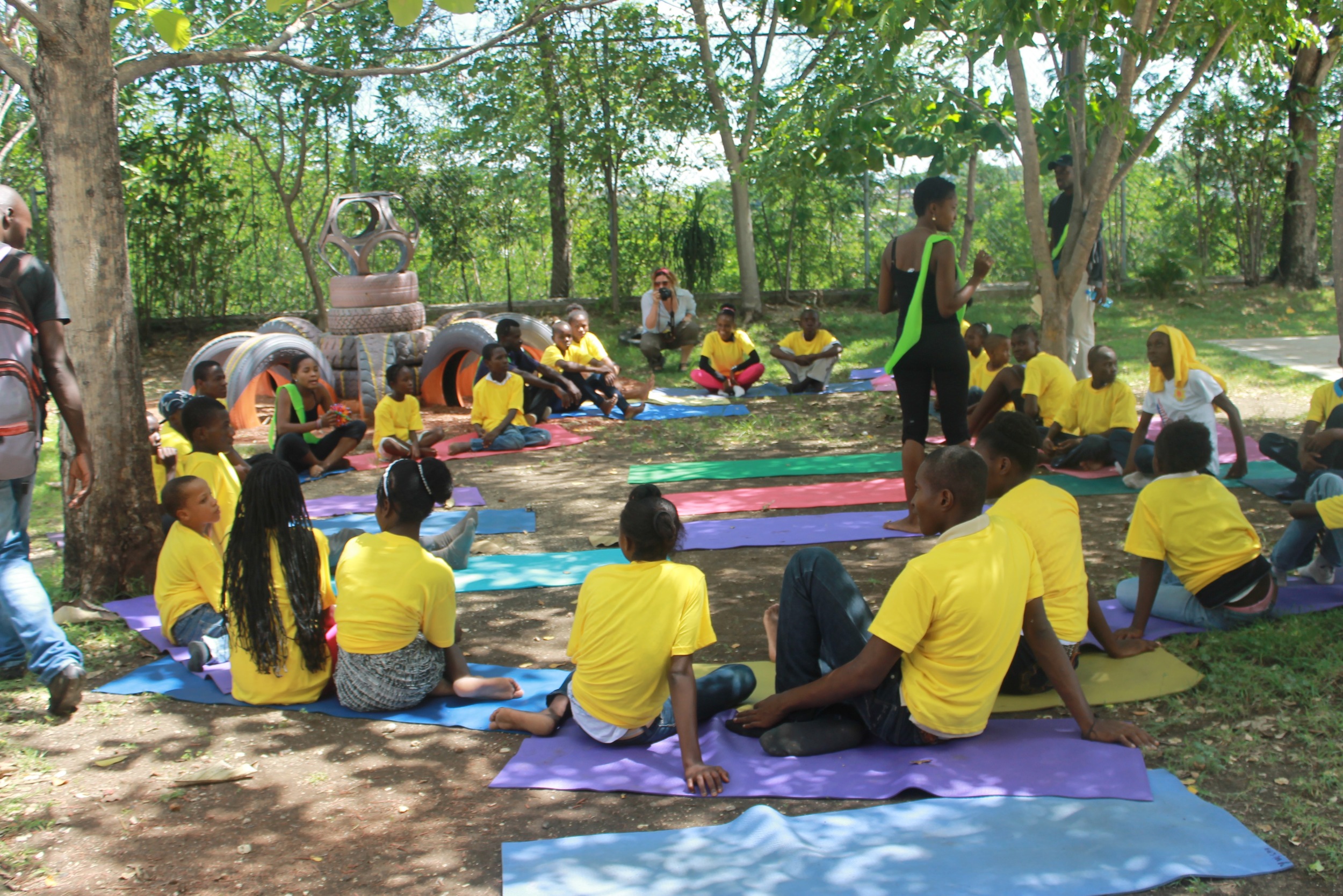 Ayiti Yoga leads a yoga class. (Photo credit: Max Edward Hollant)