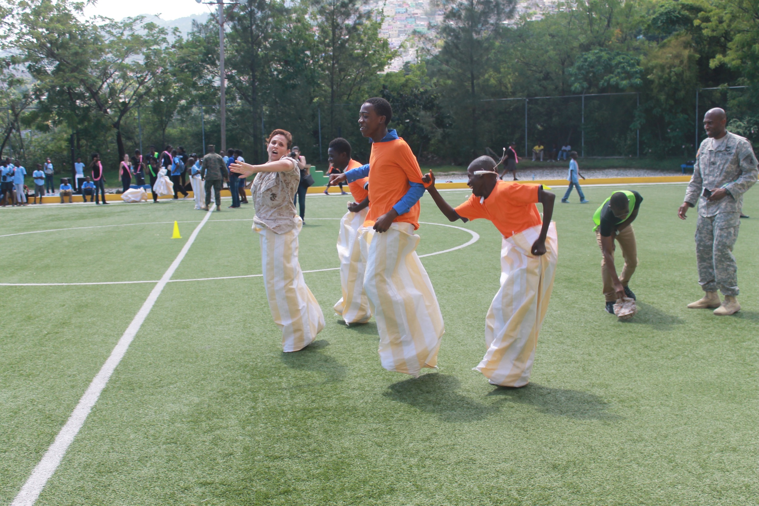   Potato sack race with member of the US Navy.  &nbsp;  (Photo credit: Max Edward Hollant)  