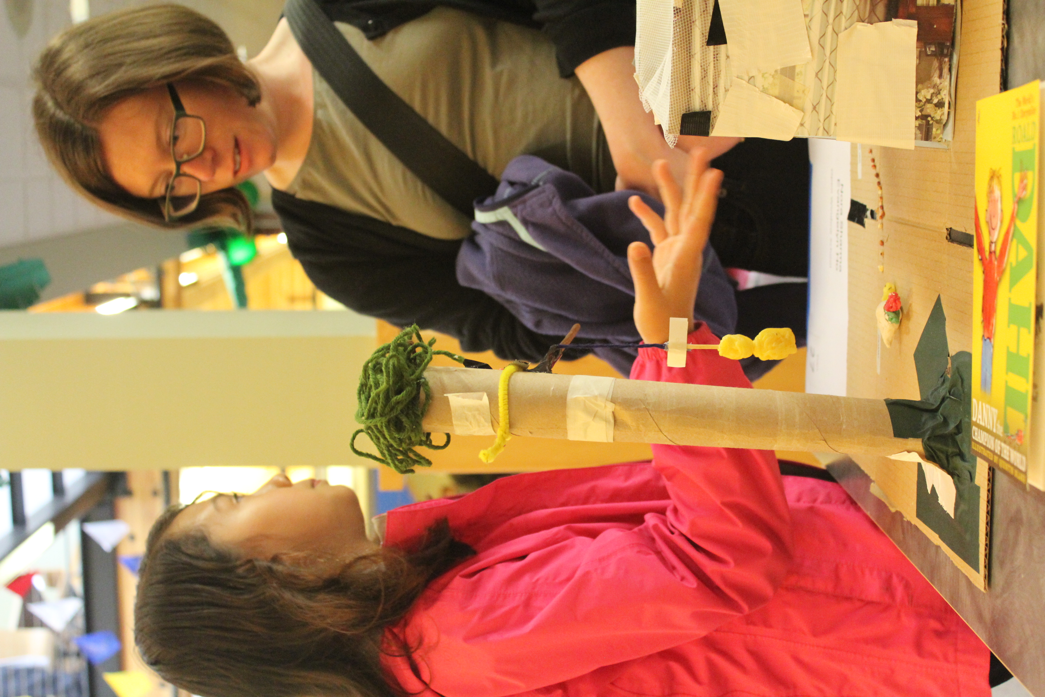 One participating student explains her team's Pheasant Trap to an attendee.