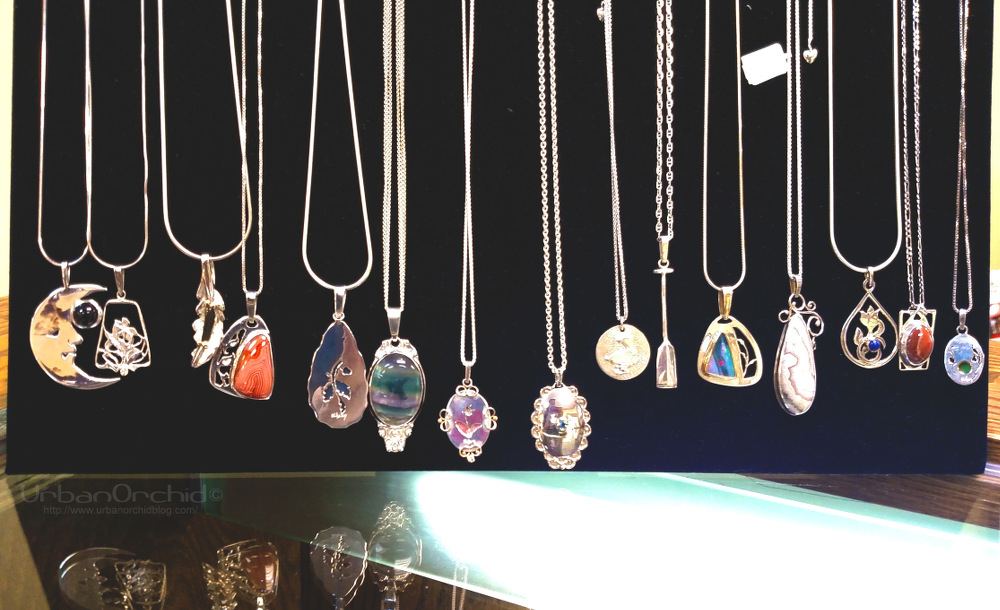Necklaces by Michael Kelsey. I love the cut out designs on some of them that can be seen through the stones. 