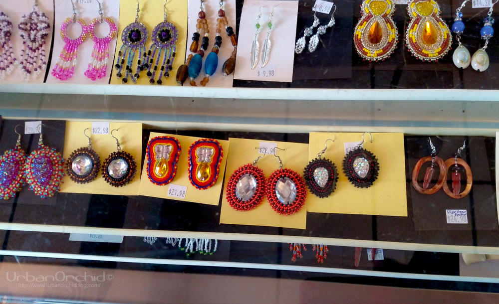 I may be easily distracted by sparkly things. Love those red and black earrings with the opalescent stone in the middle. Also, there are buttons that rotate the racks in the jewelry cases so you can see everything without having to crouch over. 