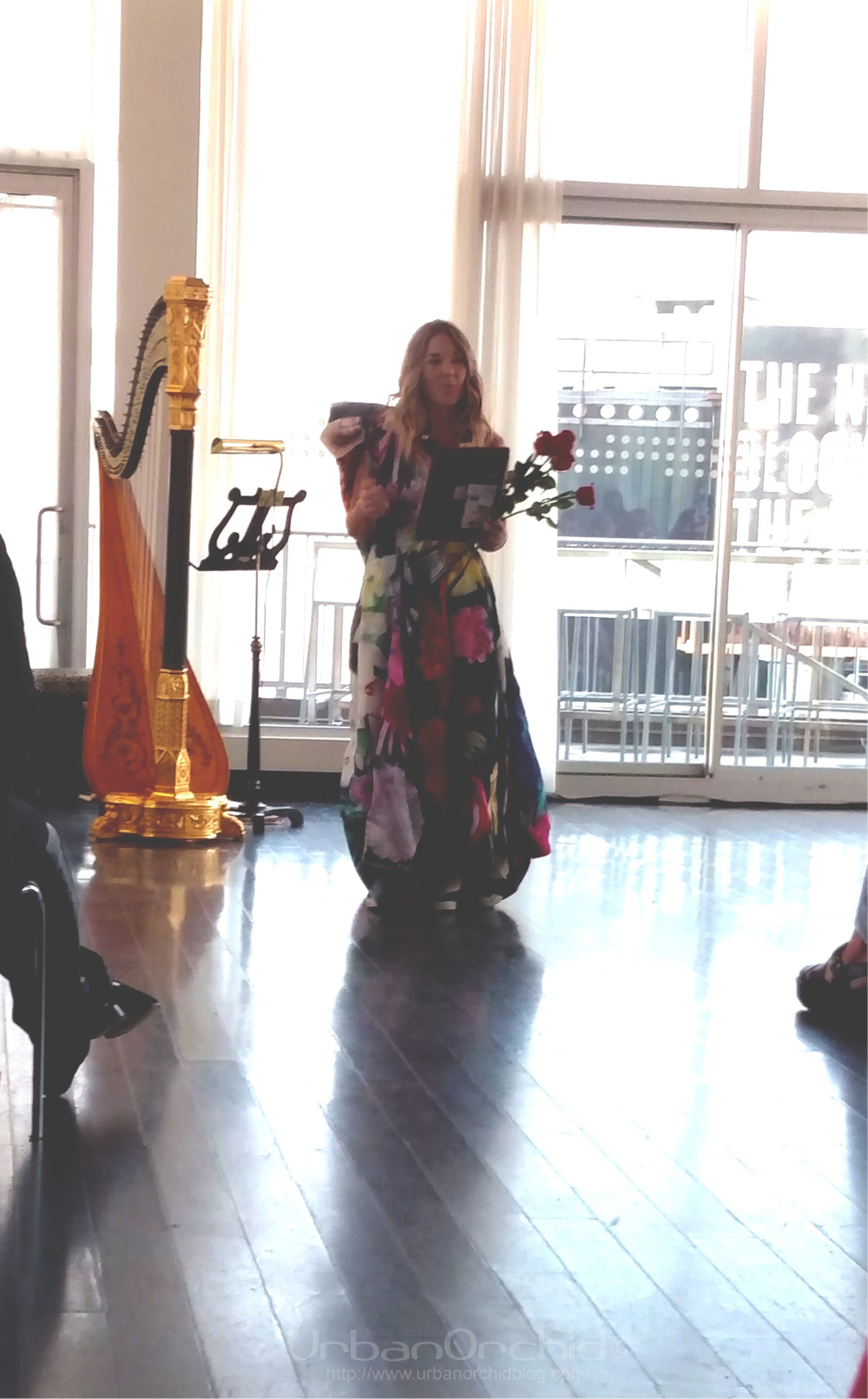 Sarah Edwards in a floral dress by Emma Berg. 