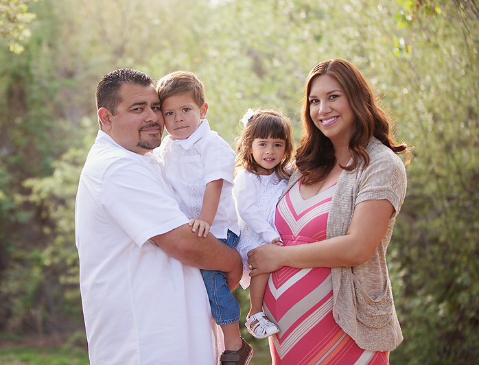 This picture represents prayers answered and a dream come true for my husband and I. It is our favorite because it is our family. After struggling to conceive for 5 years we were able to conceive our twins through in vitro. We continued to face obstacles as the twins were born very premature. The idea of being able to conceive naturally was never a thought of ours after everything we had been thro ugh until we were blessed with the surprise pregnancy of our now 8 month old baby girl. Because of complications during my pregnancy with the twins we were unable to have professional maternity pictures. With the second pregnancy going smoothly we couldn't wait for the opportunity to have maternity pictures taken not only of myself but of my family. Julie you captured what we once thought was unachievable......A family. This picture represents the pure essence of that and is a memory of a beautiful day we will have for the rest of our lives!