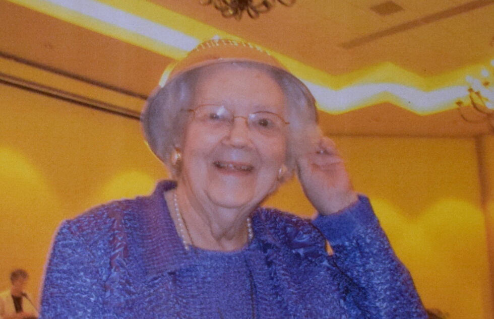 Marge celebrates winning the Maslin Award by putting the silver bowl trophy on her head for a hat!