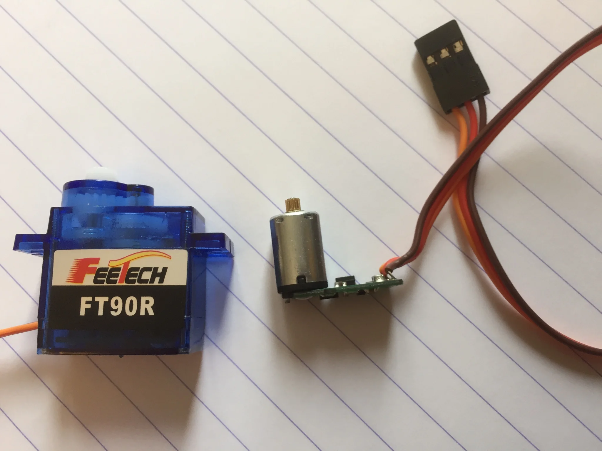 The Feetech has the motor soldered directly to the board, hence the odd shape and large solder-through holes.