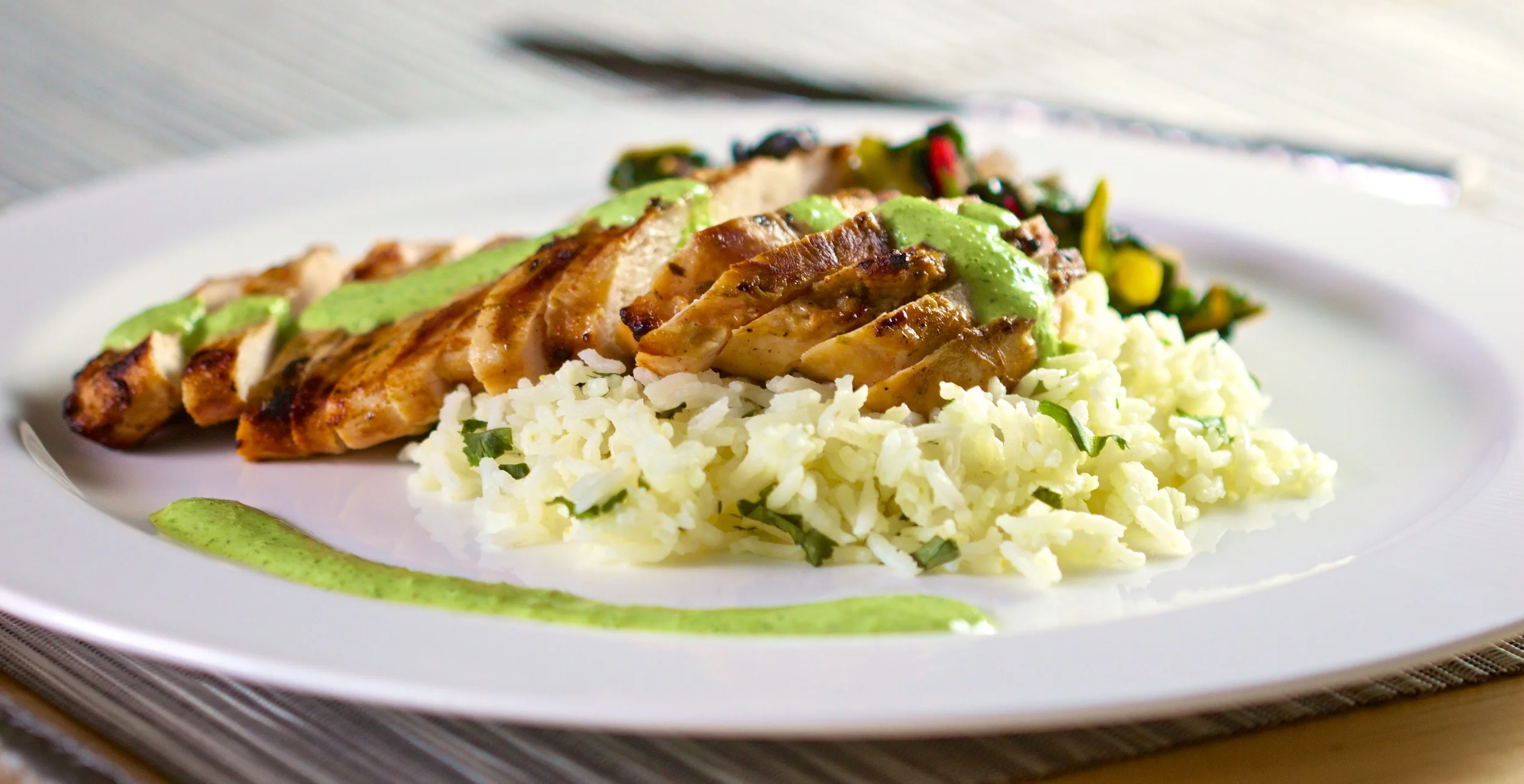Grilled chicken over cilantro lime rice with roasted jalapeno sauce