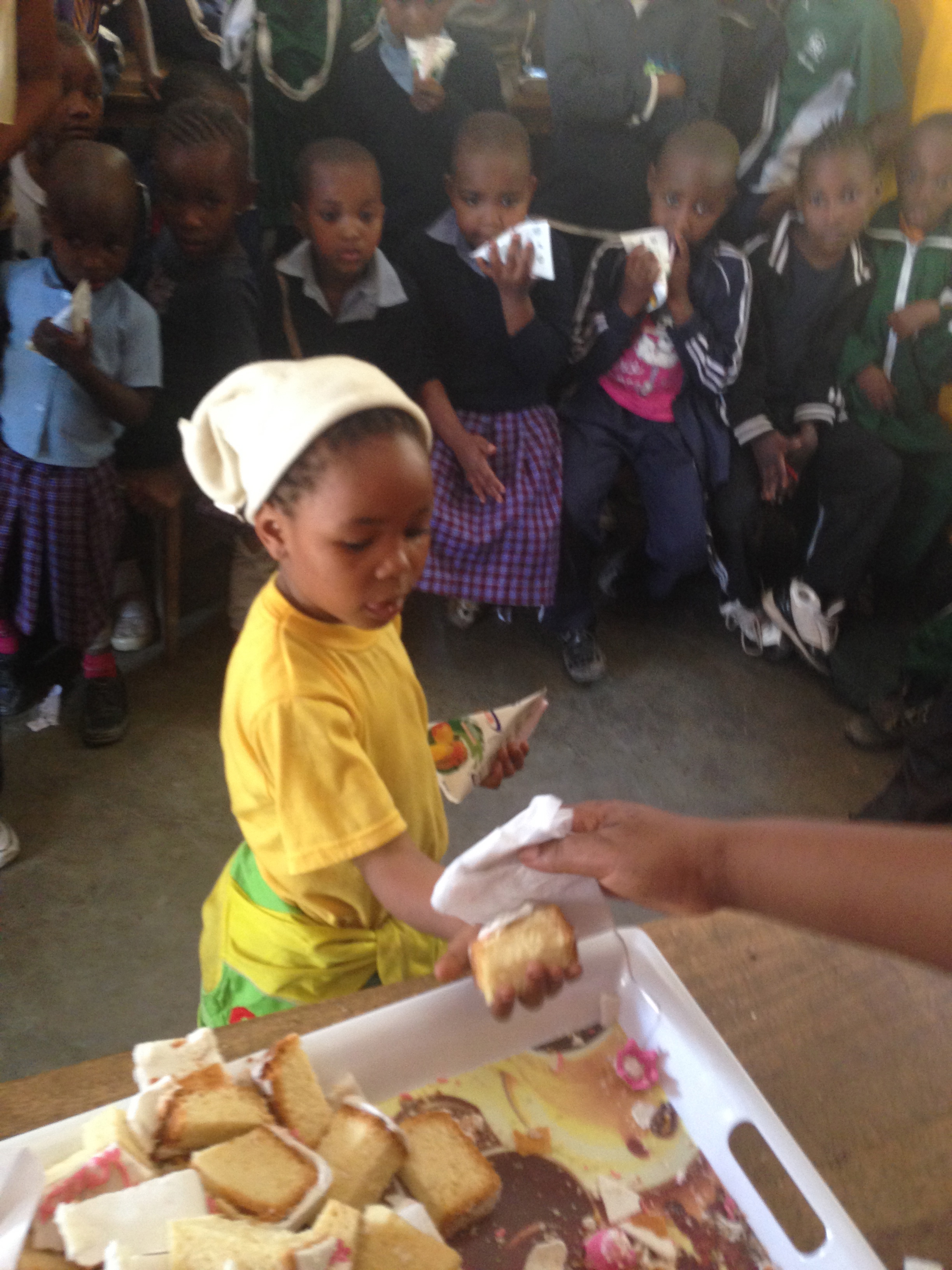 Here is Alice handing out tasty pieces of cake to each of the kids!
