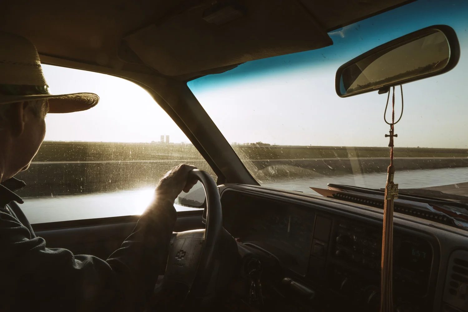 Mr. Hurley driving beside a canal managed by his company.