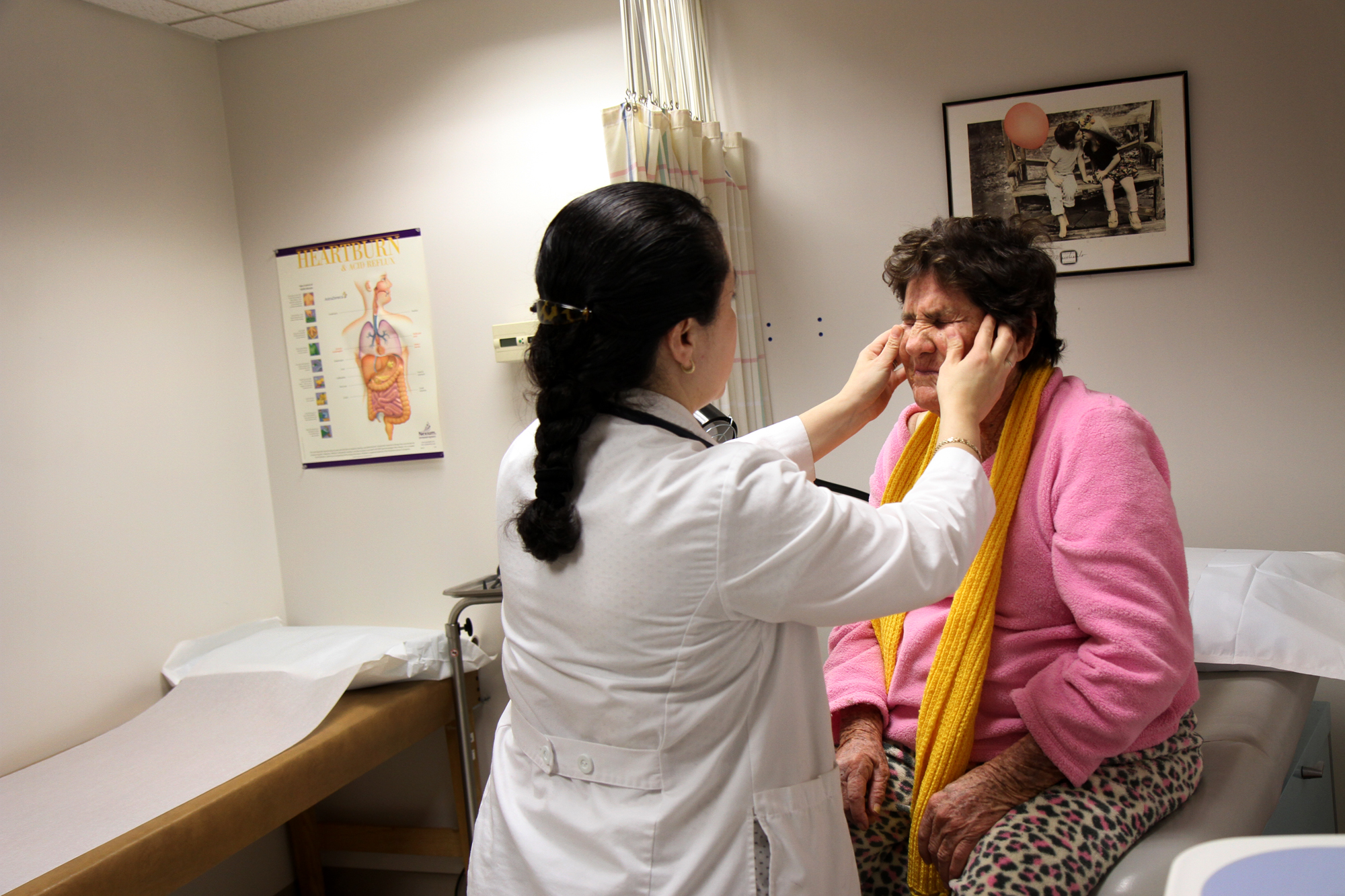 Nurse Practitioner Mirella Nguyen checks patient Modesta Pena Nunez vision, at Rotacare. Nunez has a history of abuse and has been seeing Nguyen about her possible onset dementia. Her family is looking into her legal status as a U.S. resident, which will determine what kind of health care she can receive.