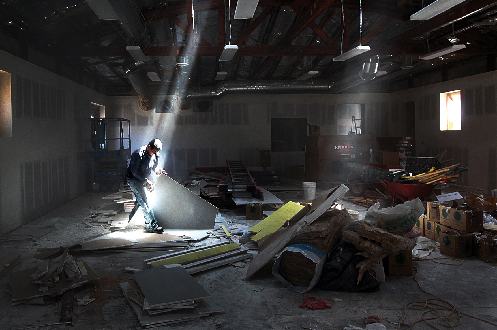 Jose Oriana sorts through left over dry wall inside the Day Worker Center of Mountain View, as major construction nears completion. 