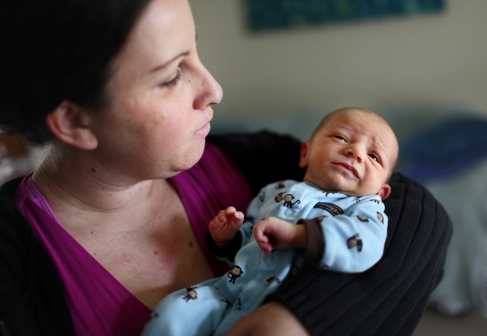 Shelby Sumner holds her newborn Jasper in her living room. Jasper was born with missing fingers on his right hand. Doctors have ruled out any genetics as a factor. Shelby had been living on base for two years, and became pregnant during that time. 