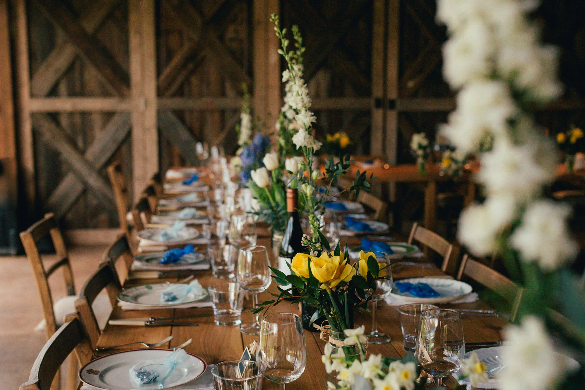 Dewsall Court dressed vintage beer bottles filled with spring flowers Photography by Lucy G Photography