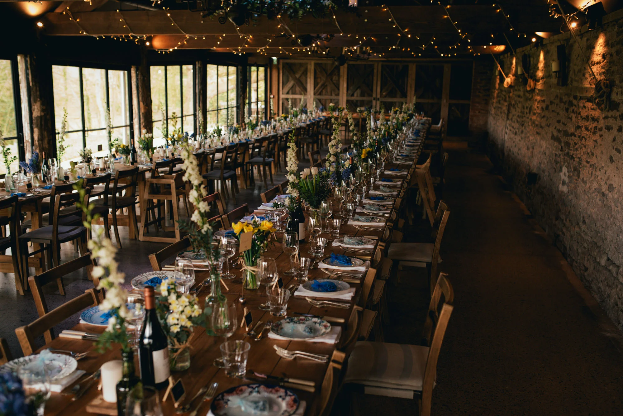 Dewsall Court dressed vintage beer bottles filled with spring flowers Photography by Lucy G Photography