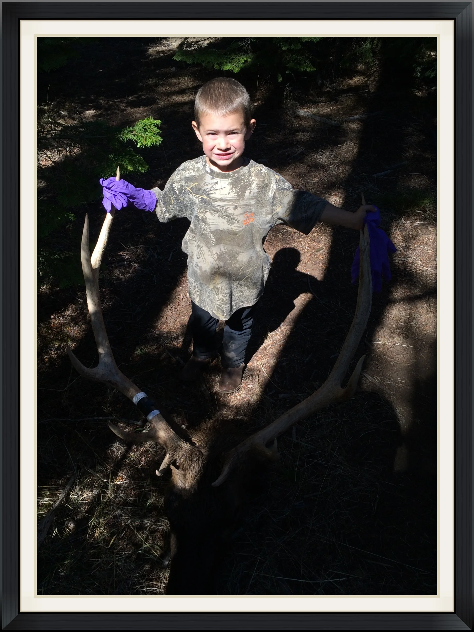 Holding his Daddy's bull. This young man might just grow up to be the best hunter of them all.