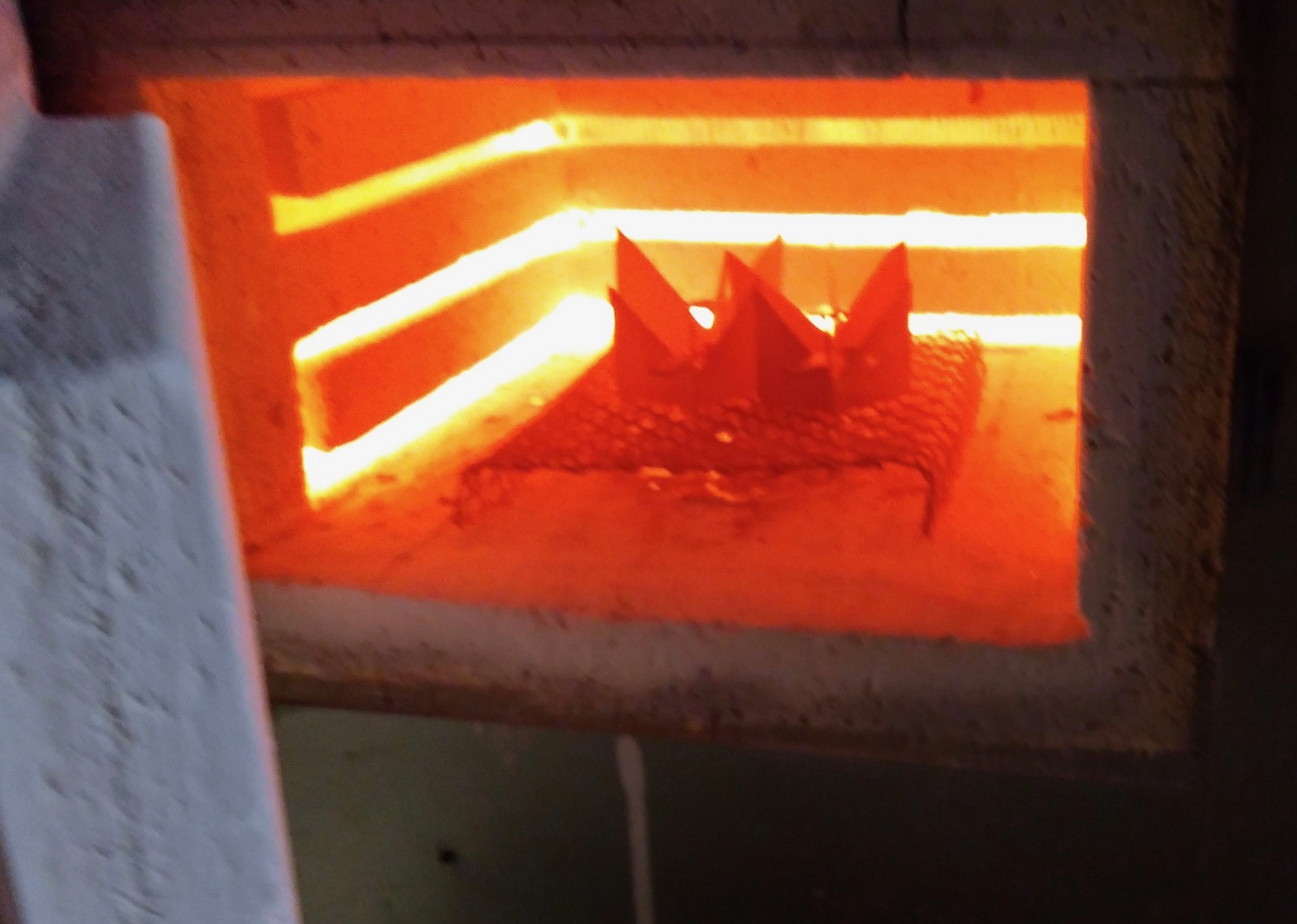 enamel pieces being fired inside one of my kilns that my father used to use