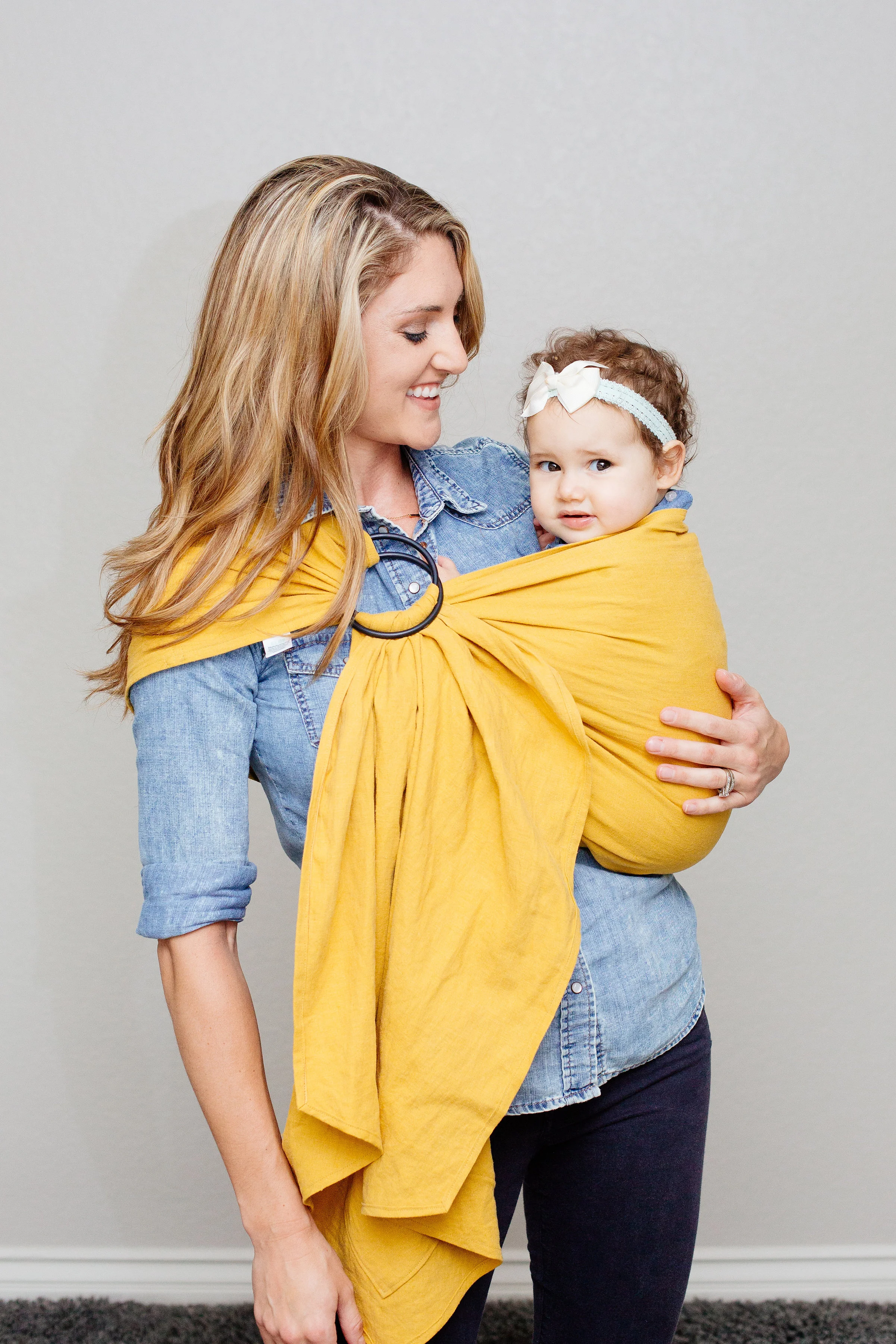 Once on the hip, pull fabric up flat against their back, then pull fabric between their legs up towards their belly button. All weight should be in their seat, knees higher than their bum.