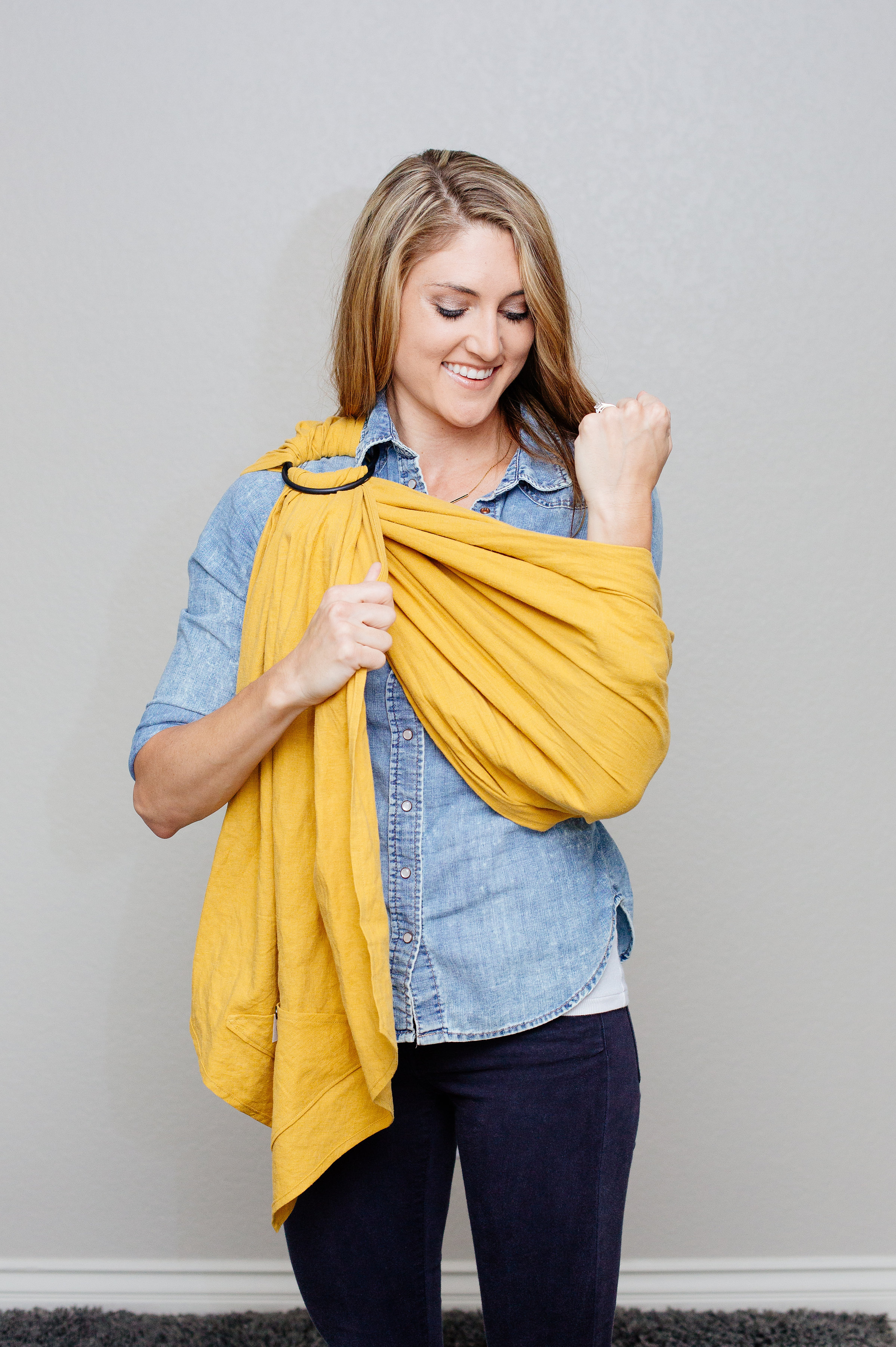7 With the rings high on your shoulder, tighten the sling around your elbow before putting baby in the sling so there is minimal adjusting once you place your baby in the sling.