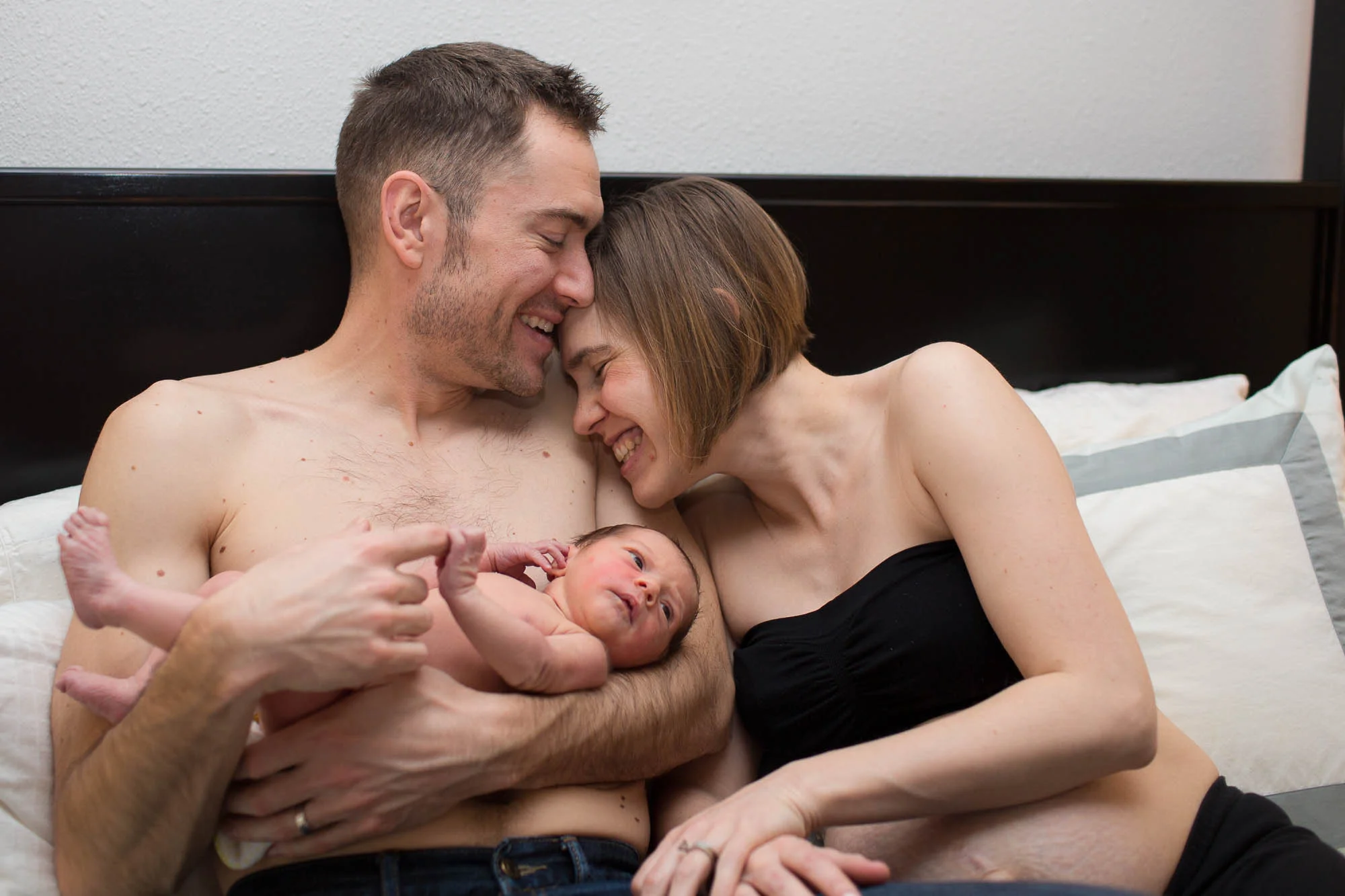Stuart and Keris laughing together. Austin in-home newborn photographer.