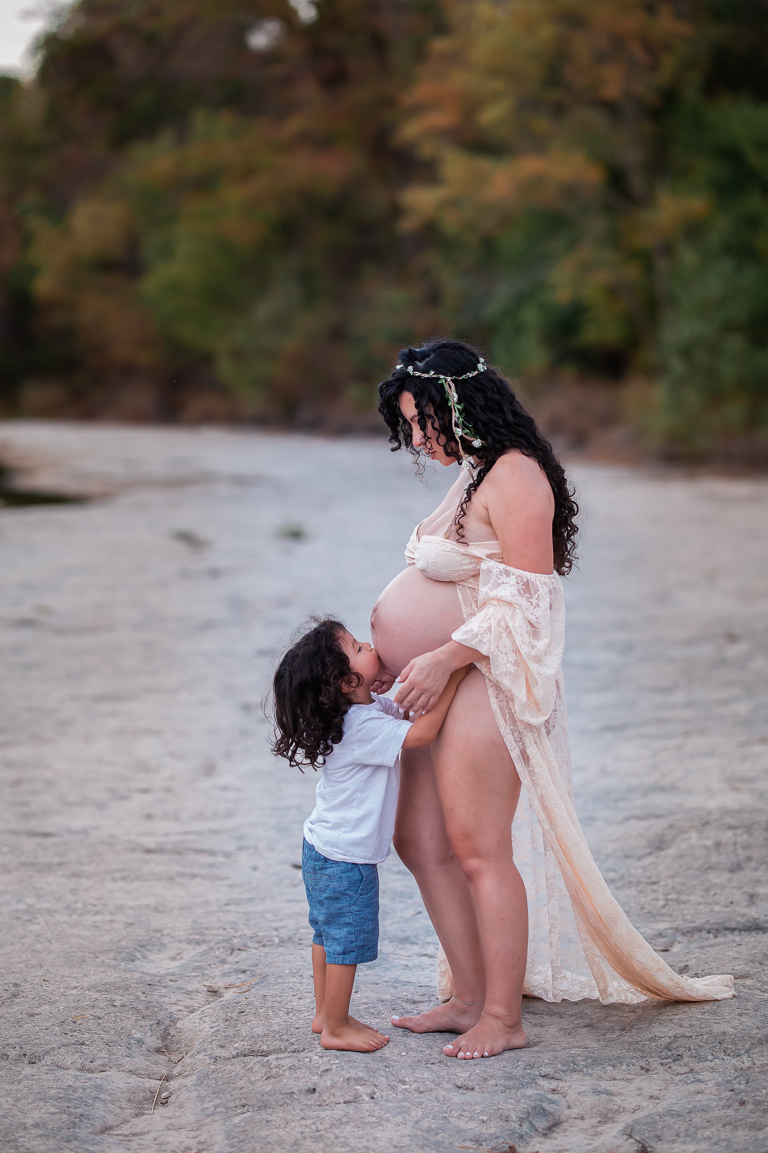  Little boy kissing mother’s belly; Austin maternity photographer 