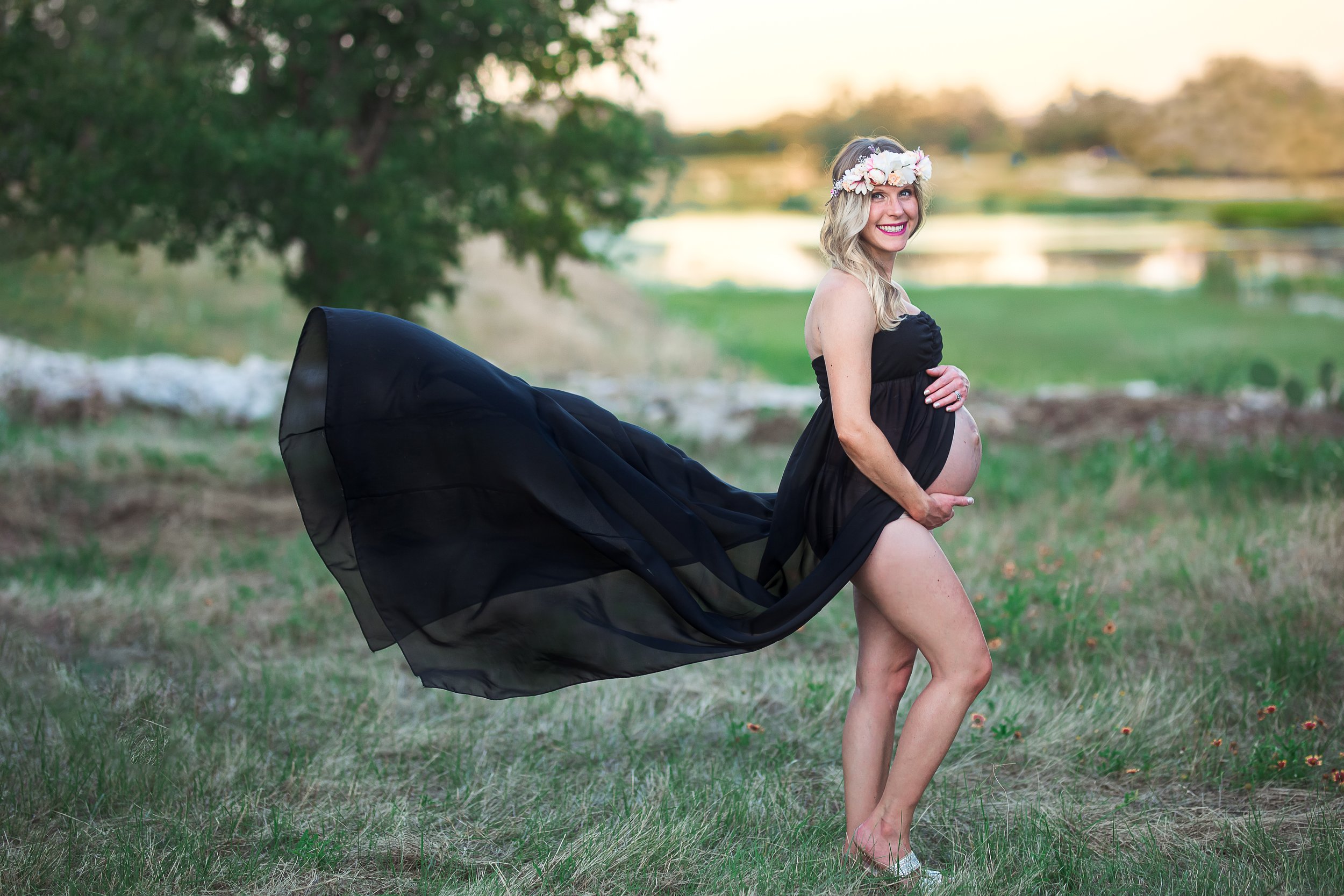 Pregnant woman with black dress blowing in the wind 