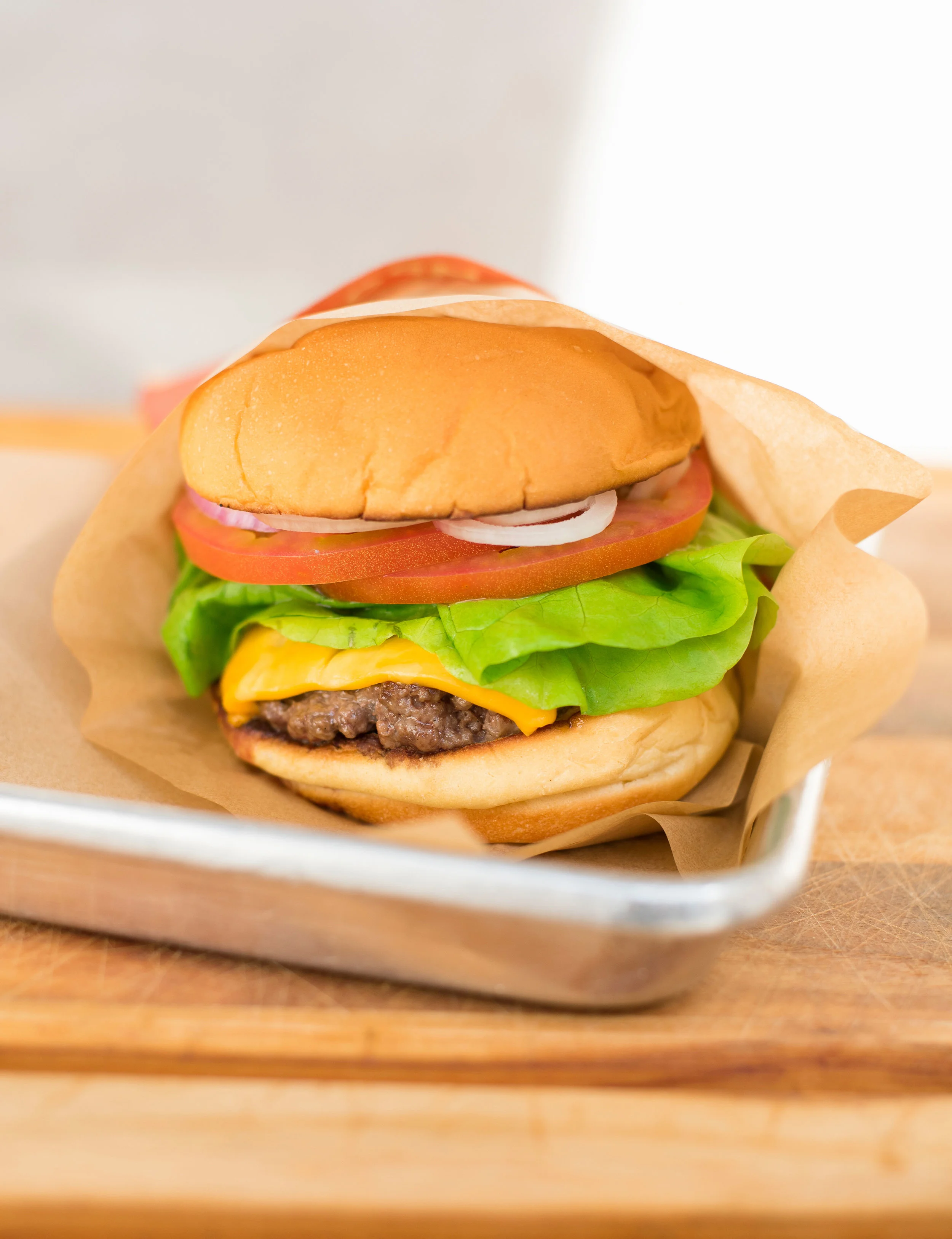 Craft cheeseburger on retro metal tray