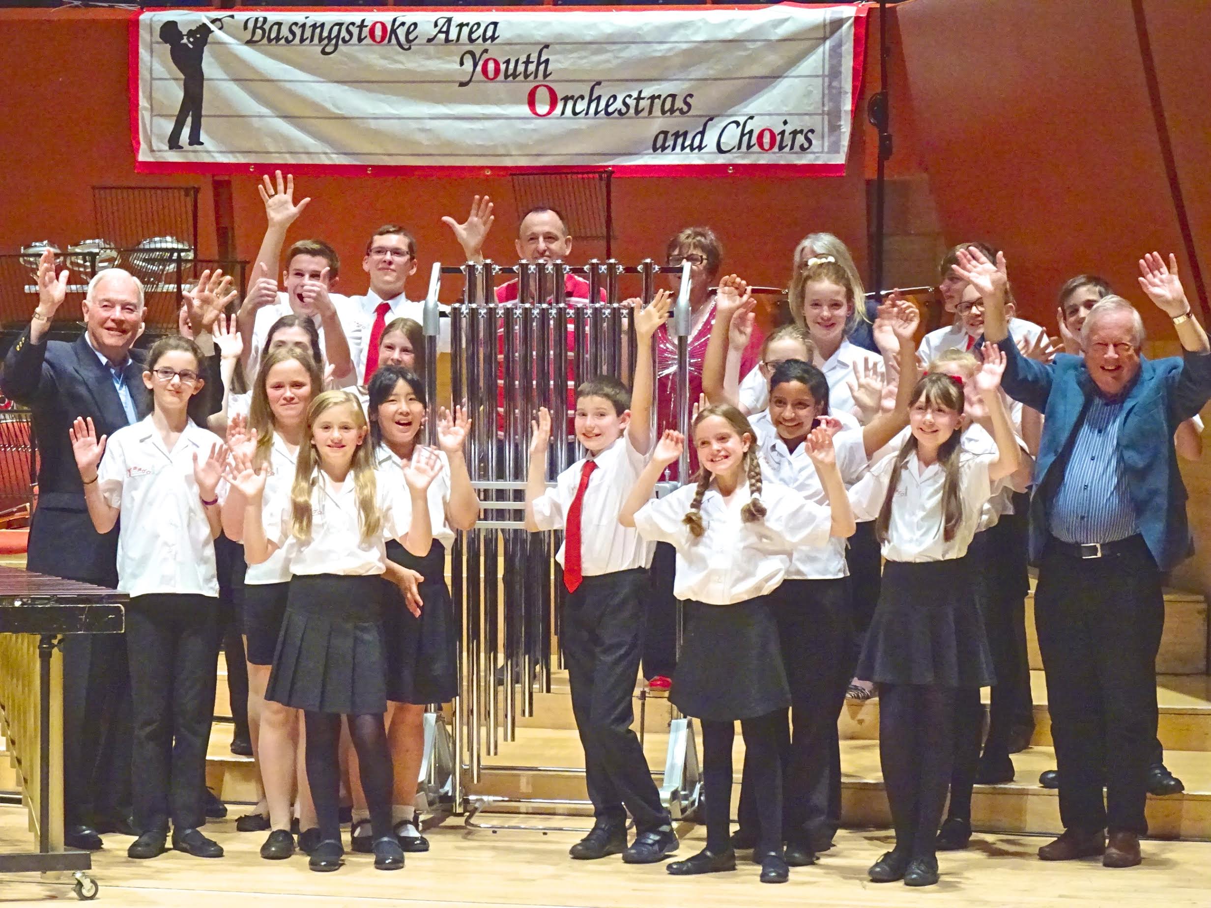 BAYPE celebrate the purchase of tubular bells, enabled by fundraising efforts of the charity, donations from anonymous parent donors (hiding behind the instrument in this image) and local county councillor grants. 2 of the councillors (seen either side of BAYPE) attended the debut concert of the instrument at The Anvil on 9th May 2015.