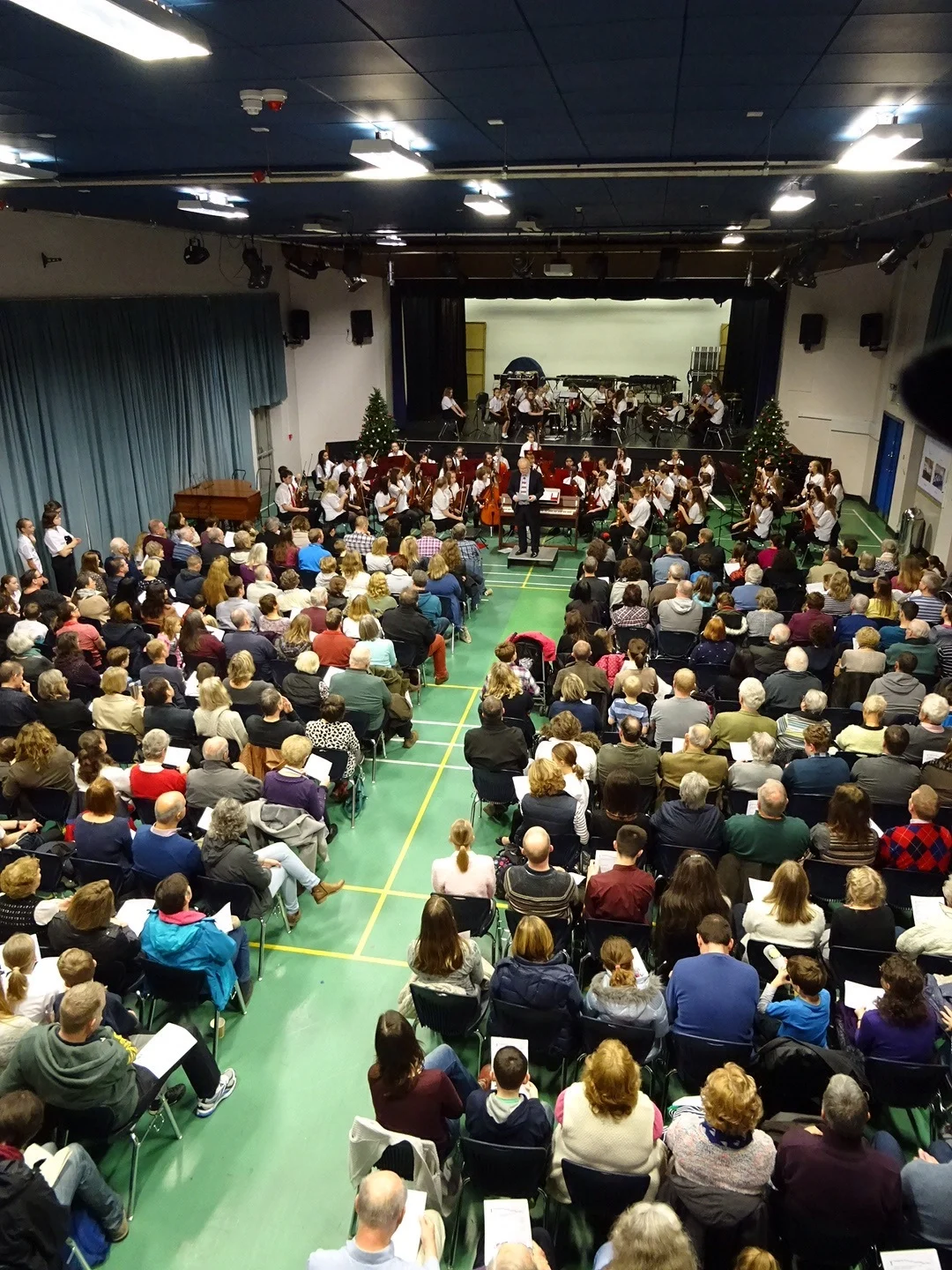 The String Orchestra with Paul Timms and on stage behind them the String Training Orchestra.