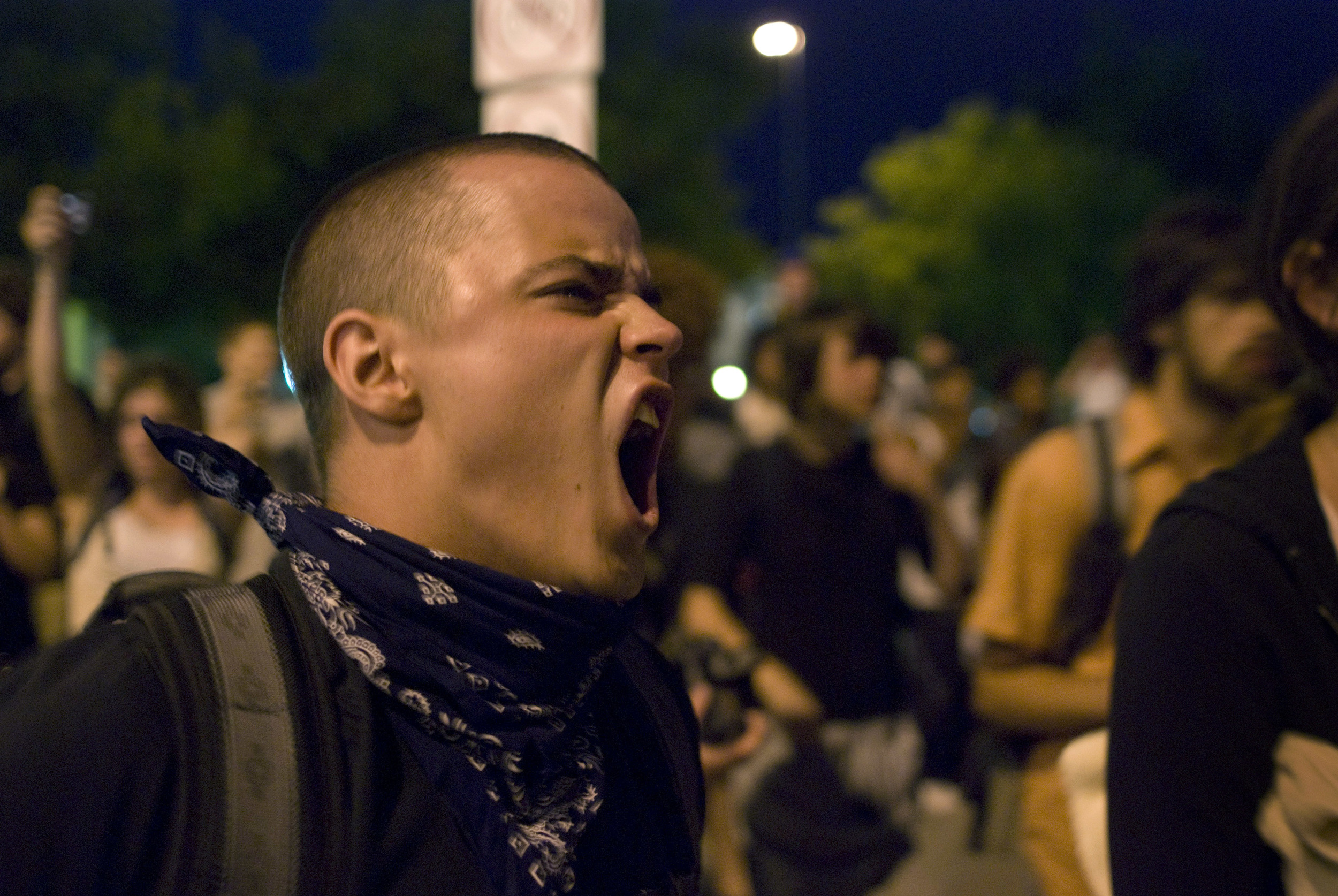 A protester on 15th Street shouts back at the three-deep line of Denver Police around 9:30PM on night one of the 2008 Democratic National Convention.